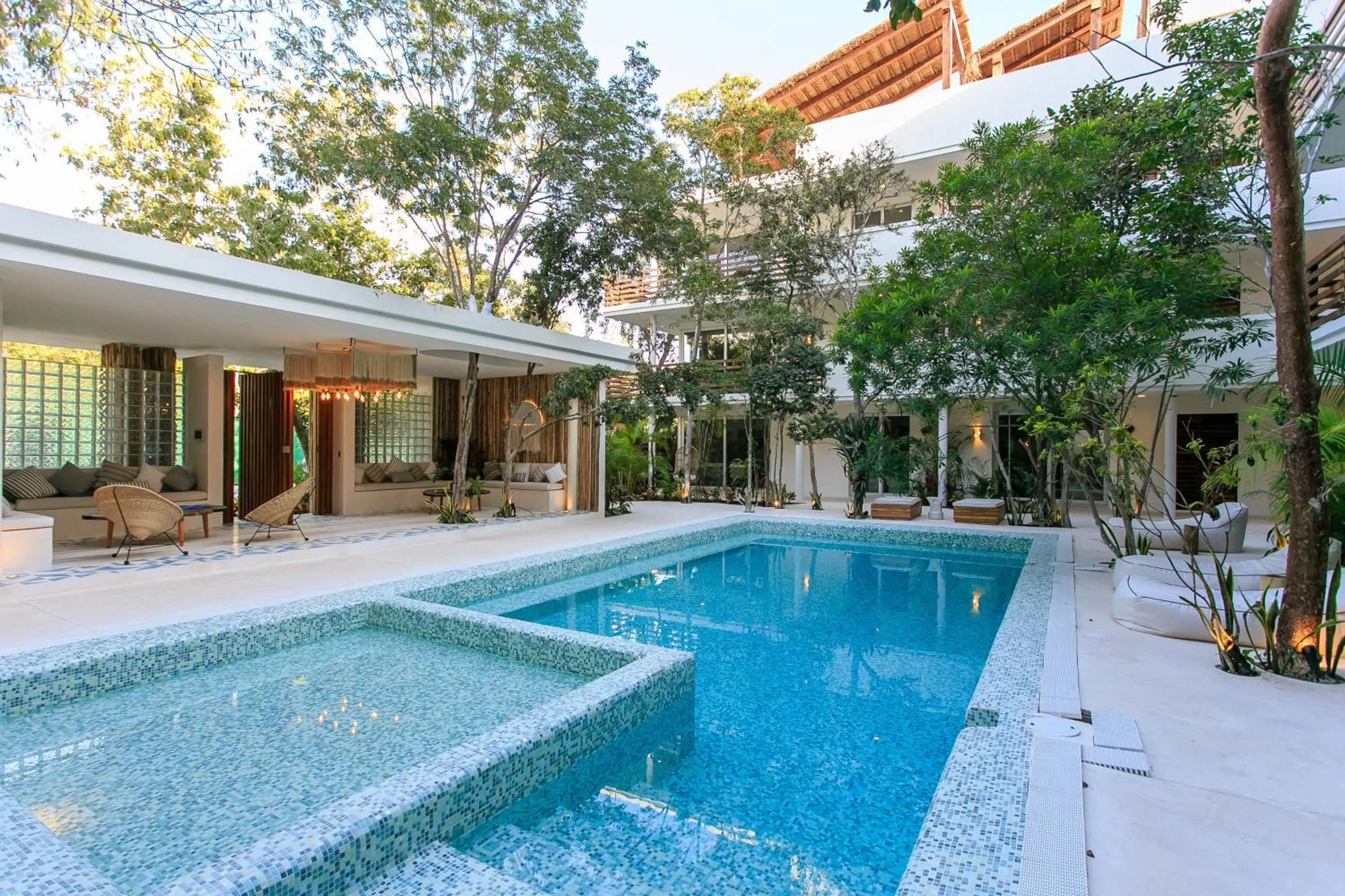 Swimming pool in Charming Nature-Inspired Condos with Sultry Surroundings by Stella Rentals