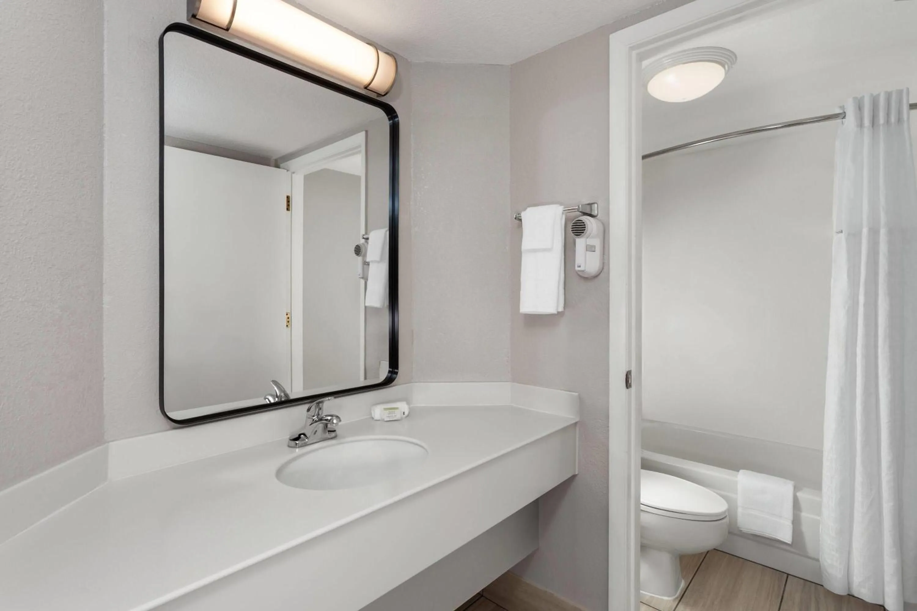 Bathroom in Days Inn & Suites by Wyndham Arlington Heights