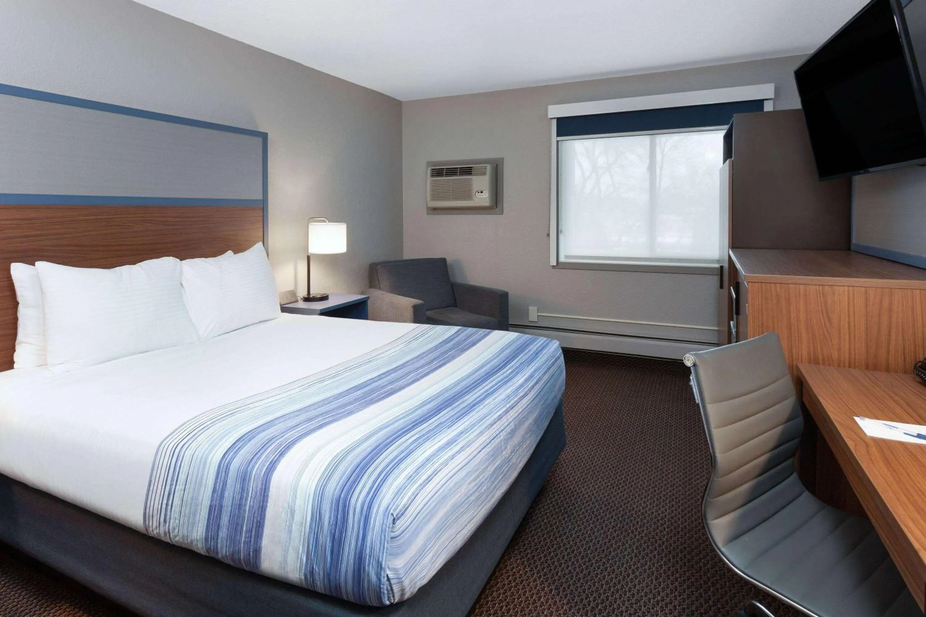 Bed in AmericInn by Wyndham New Richmond