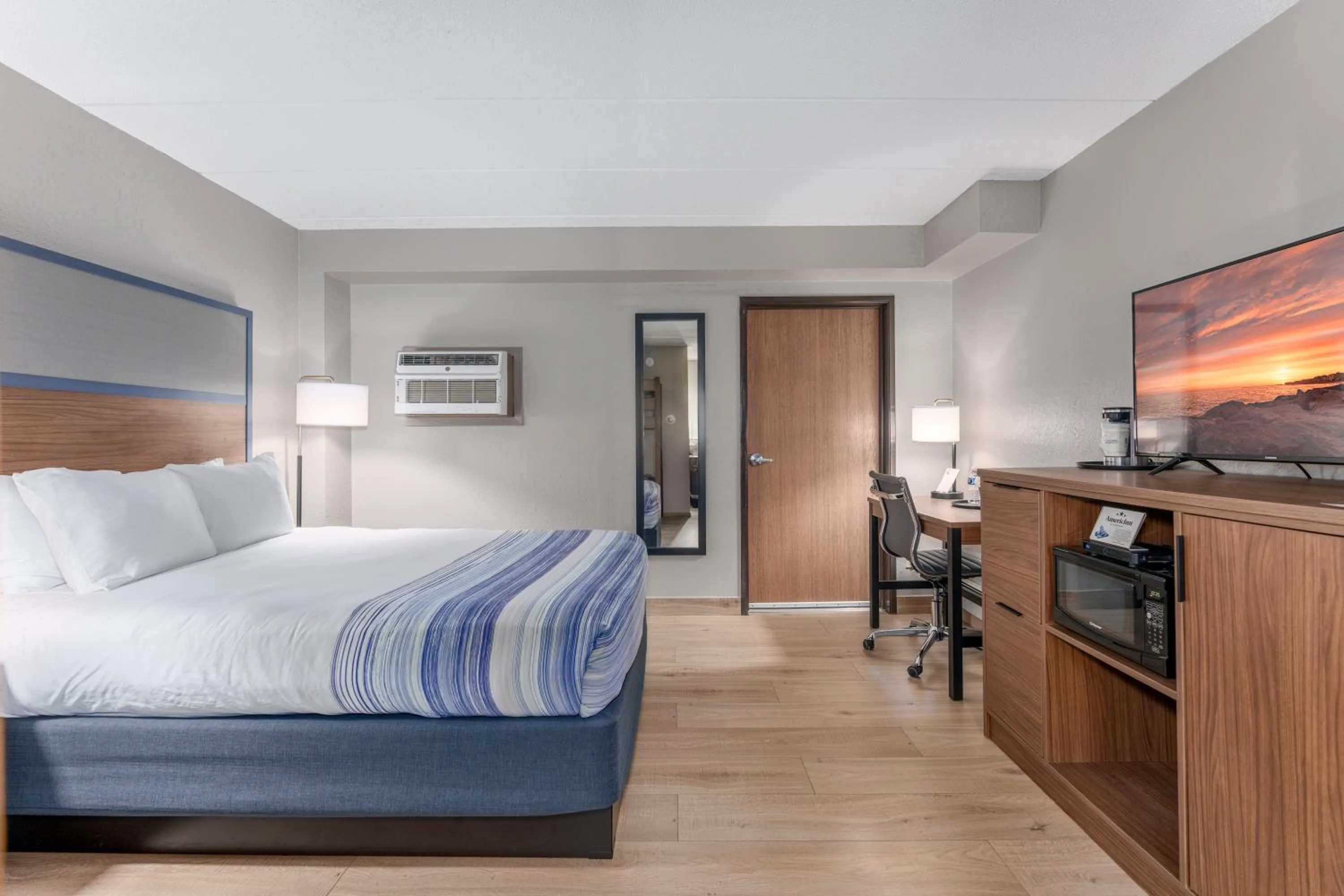 Bed in AmericInn by Wyndham New Richmond