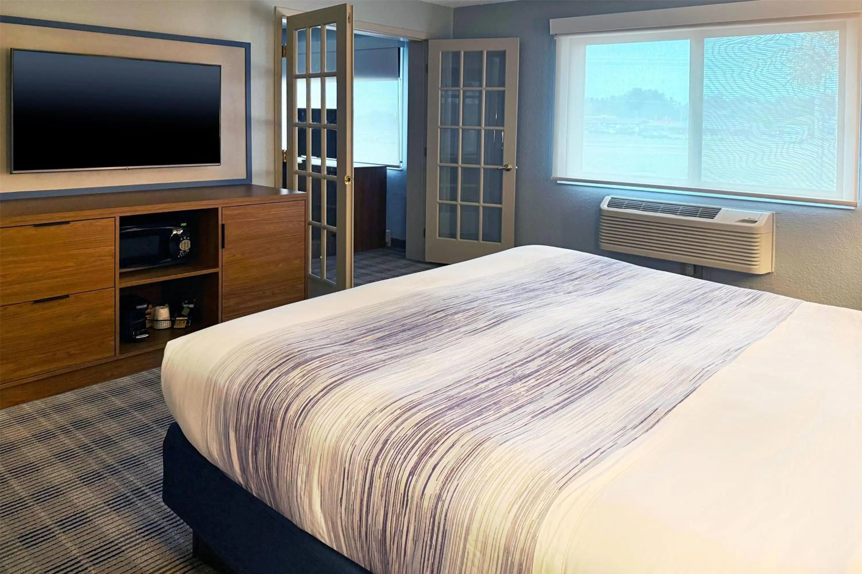 Photo of the whole room, Bed in AmericInn by Wyndham Chippewa Falls