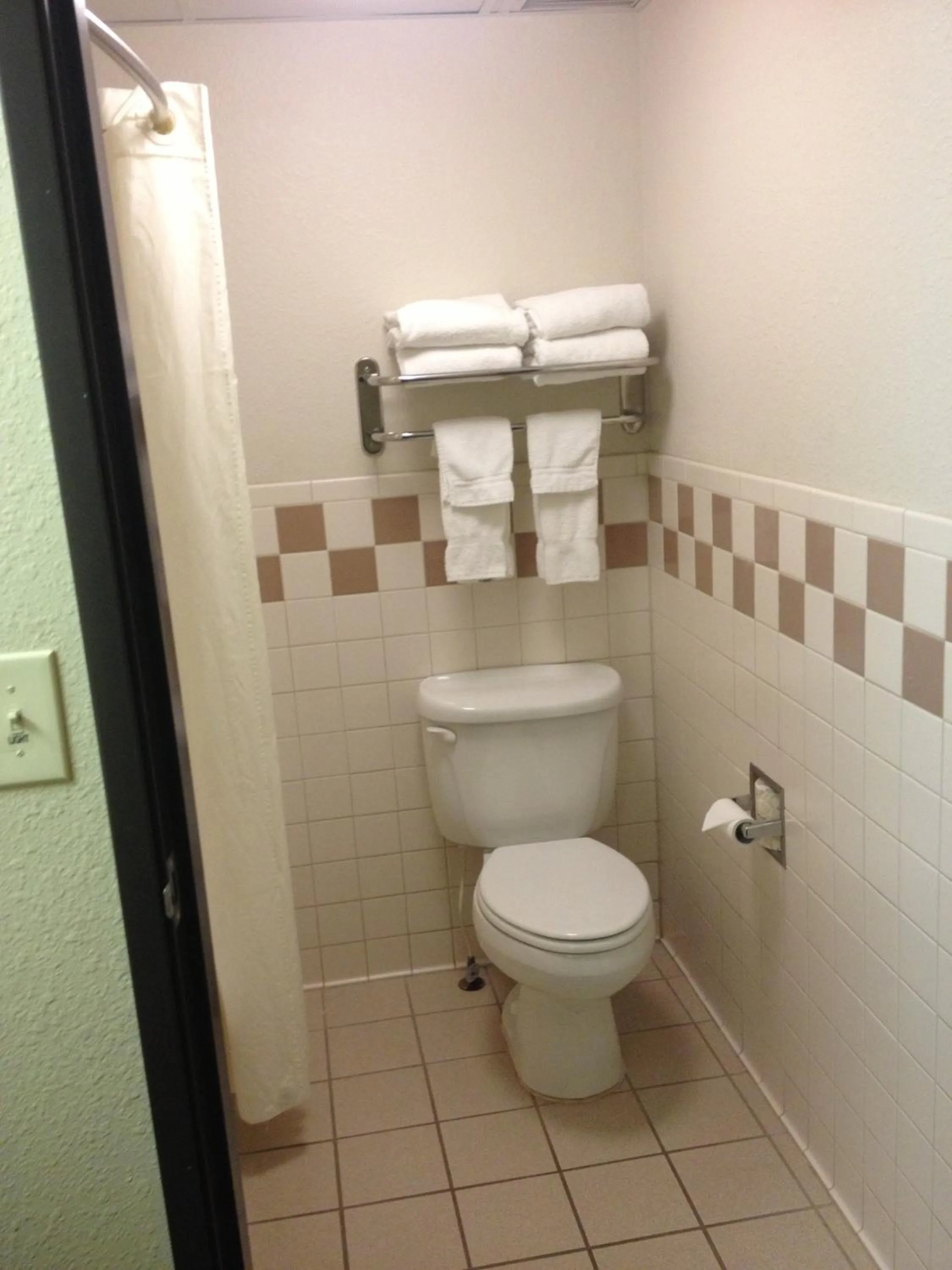 Toilet in AmericInn by Wyndham McAlester