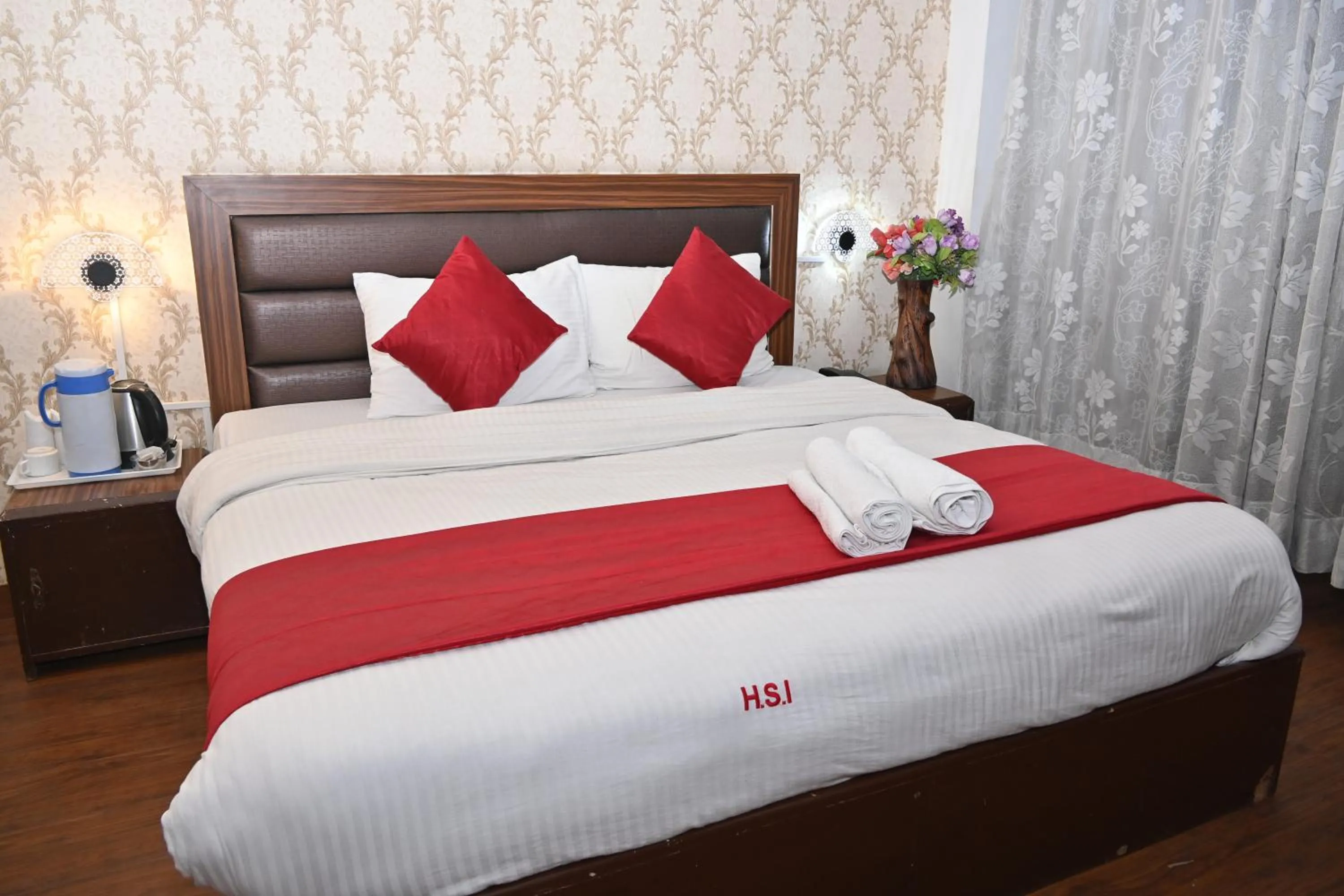 Bed in Hotel Sitara International