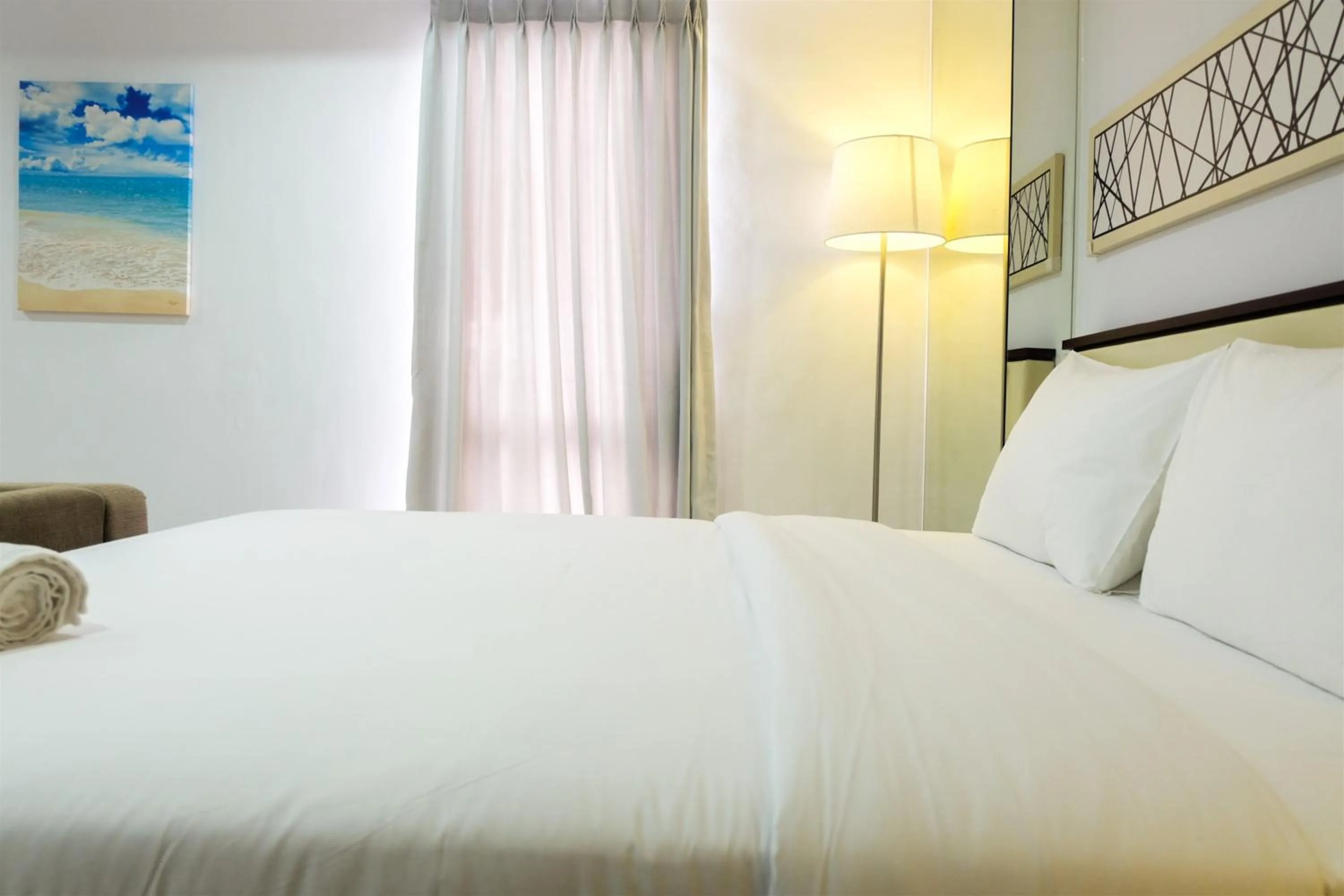 Bed in Studio Room Azalea Suites Apartment By Travelio