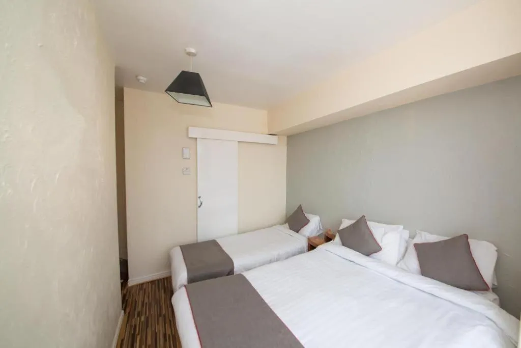 Bed in MyRoomz Hollingdales Hotel