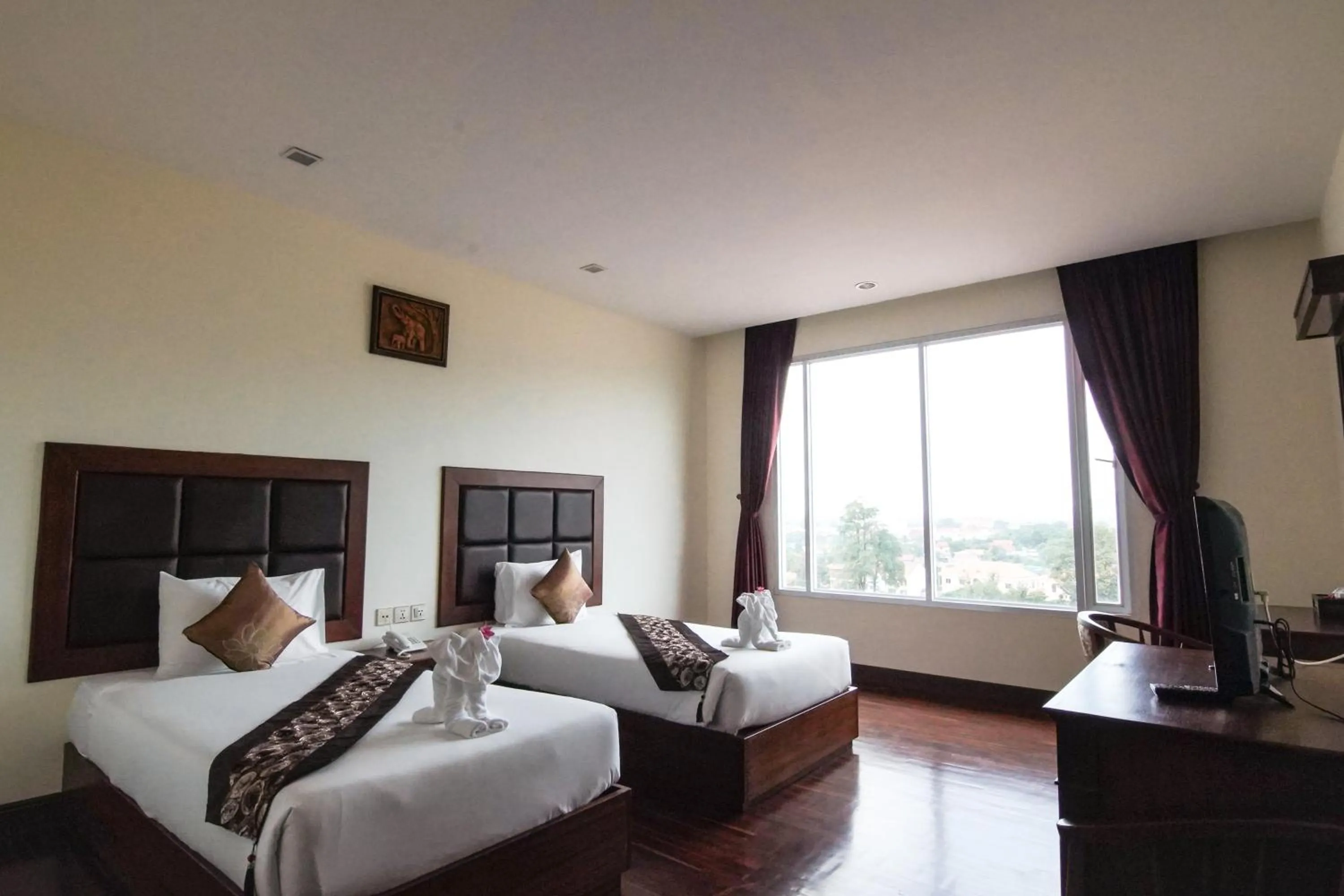 Bed in Arawan Riverside Hotel