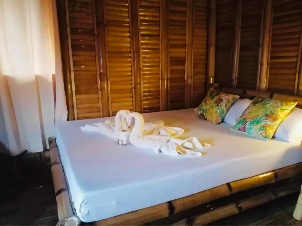 Bed in Mecaja Beach House