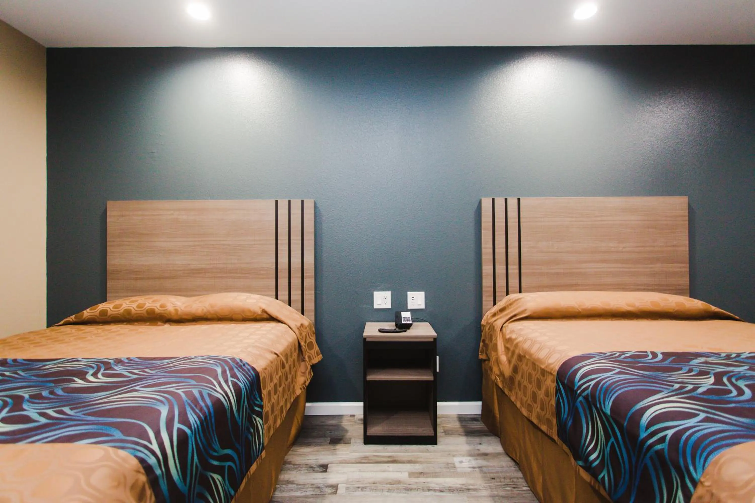 Bed in Budget Host Inn & Suites