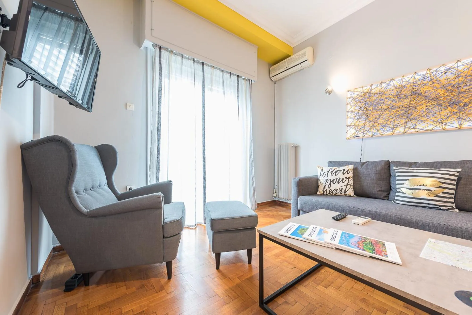 Living room in Athens Boutique Apartment by Cloudkeys