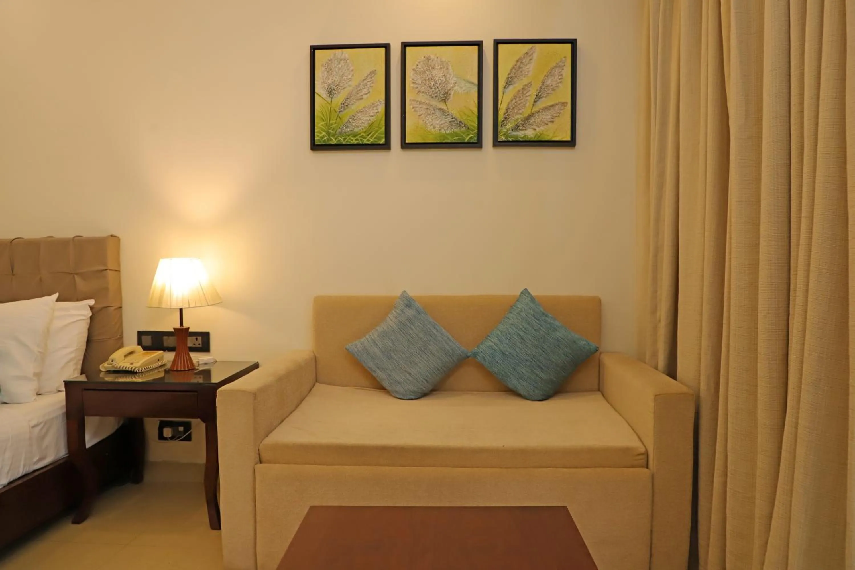 Seating area, Bed in Golden Tulip Candolim, Goa