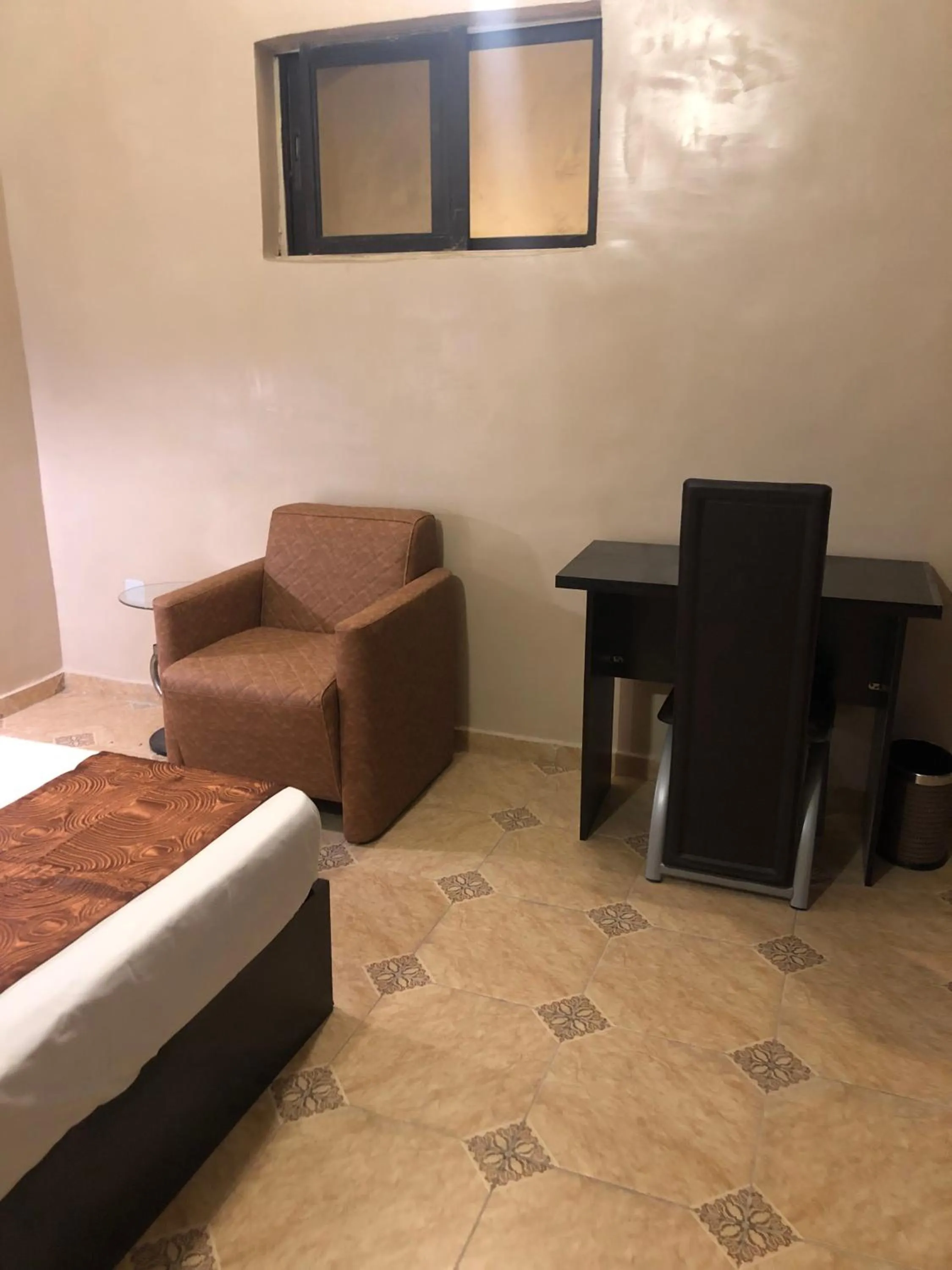 Seating area, Bed in Posh Apartments Business Hotel