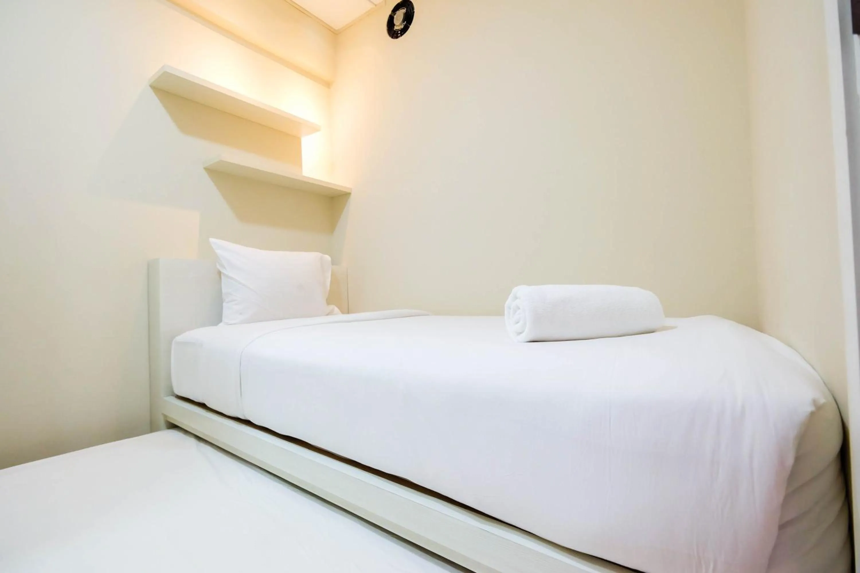 Bed in Connect to Pool 2BR Apartment at Bassura City By Travelio