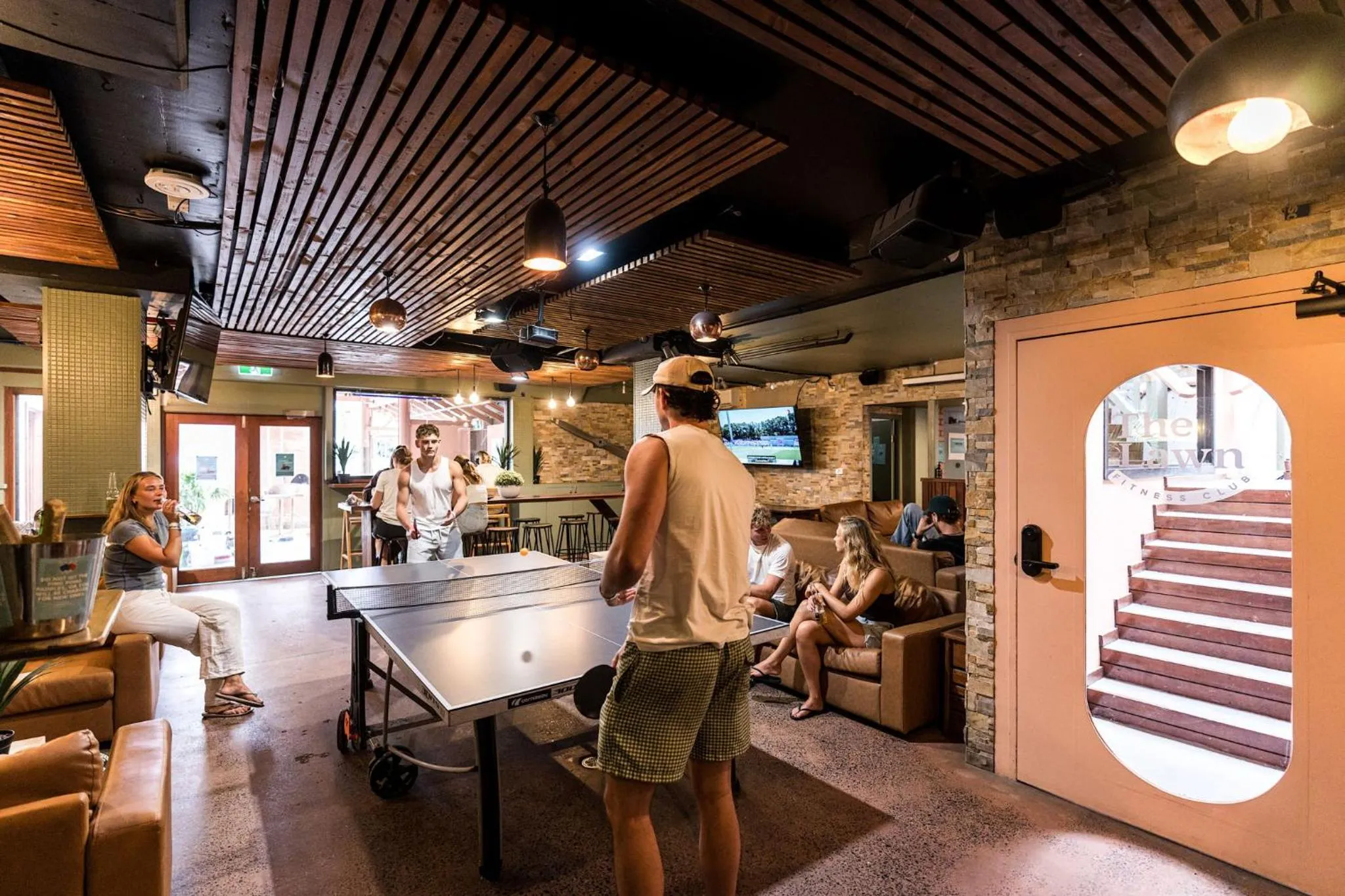 Communal lounge/ TV room in Aquarius Backpackers Resort