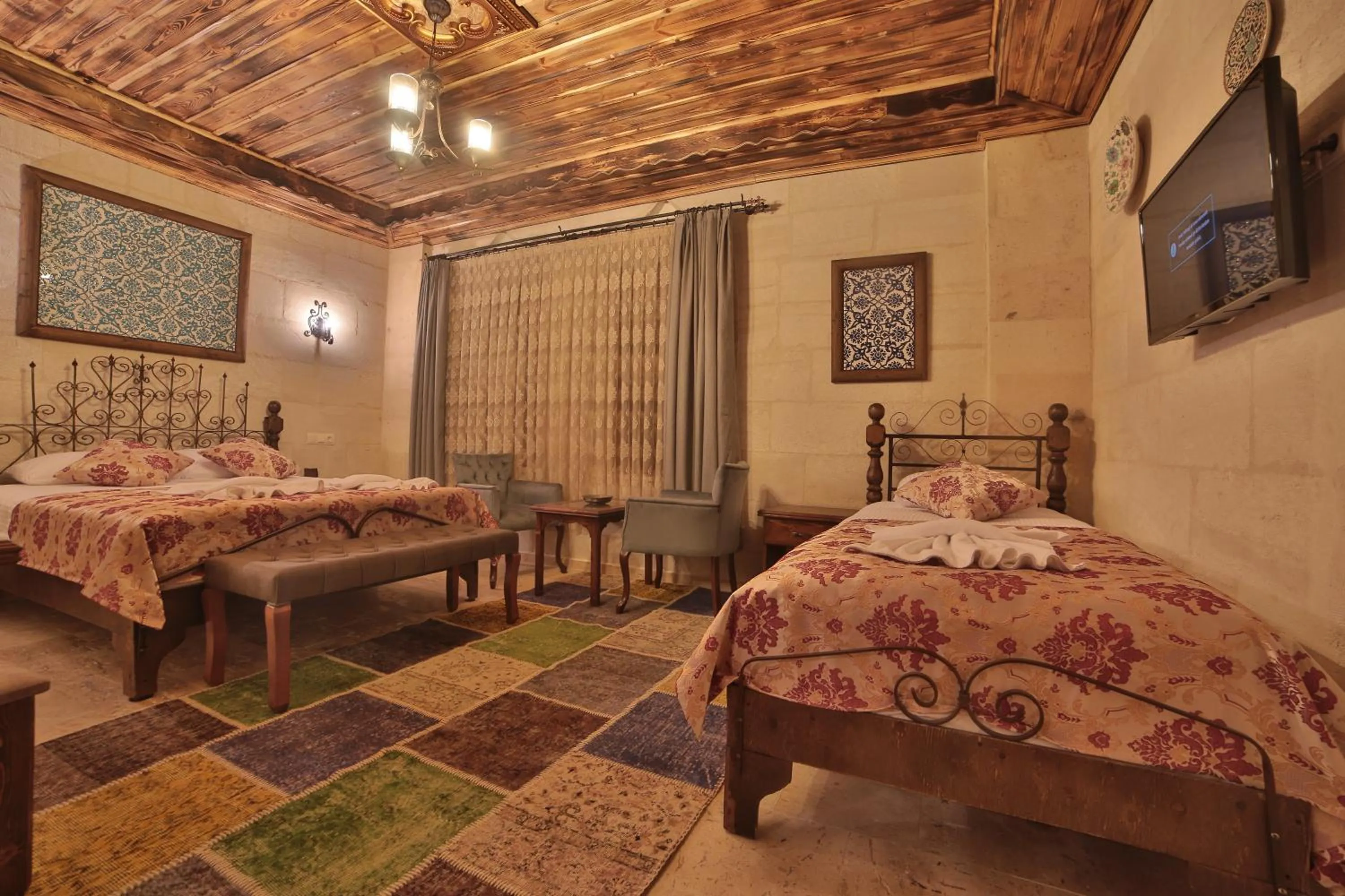 Bed in Caravanserai Inn Hotel