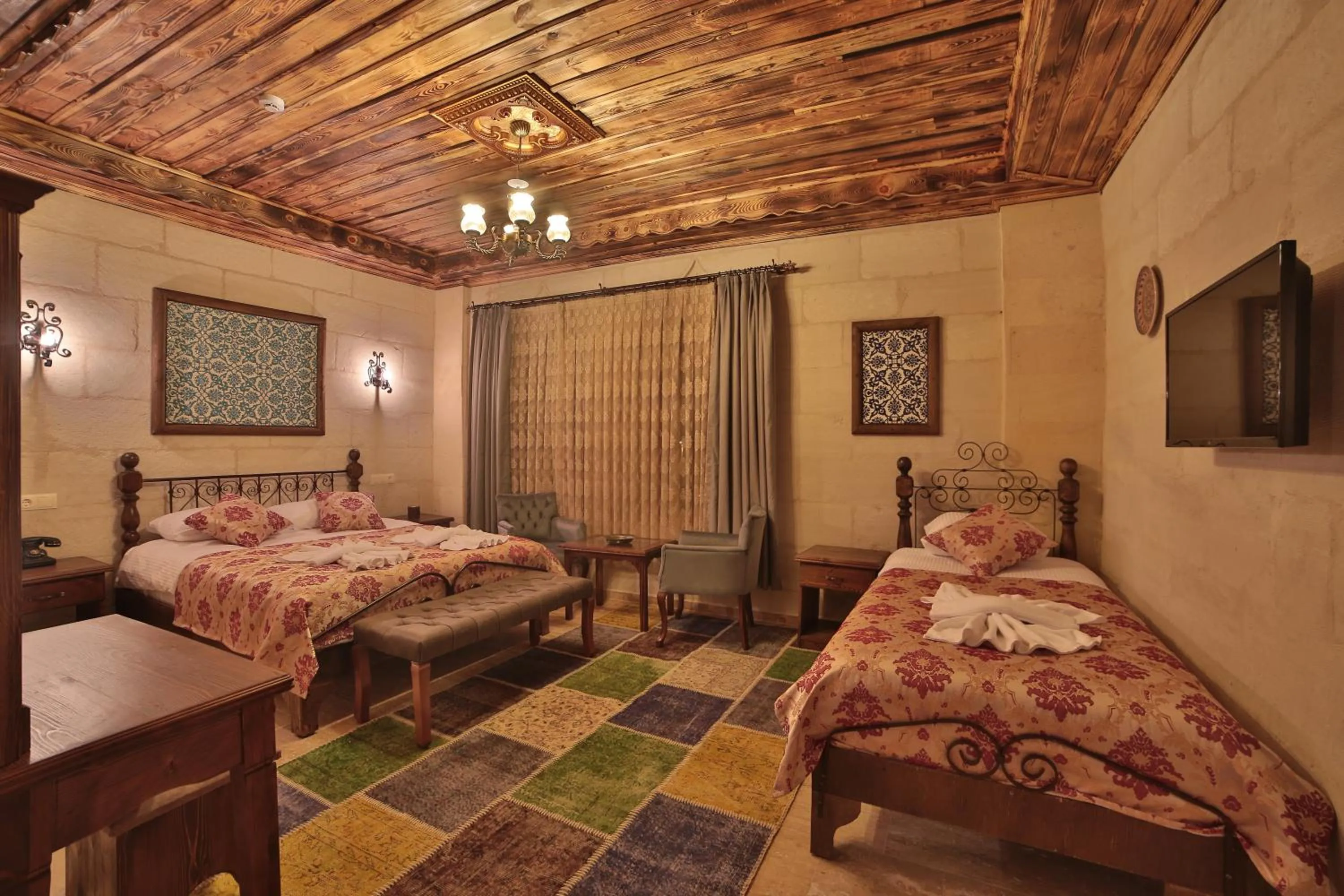 Bed in Caravanserai Inn Hotel