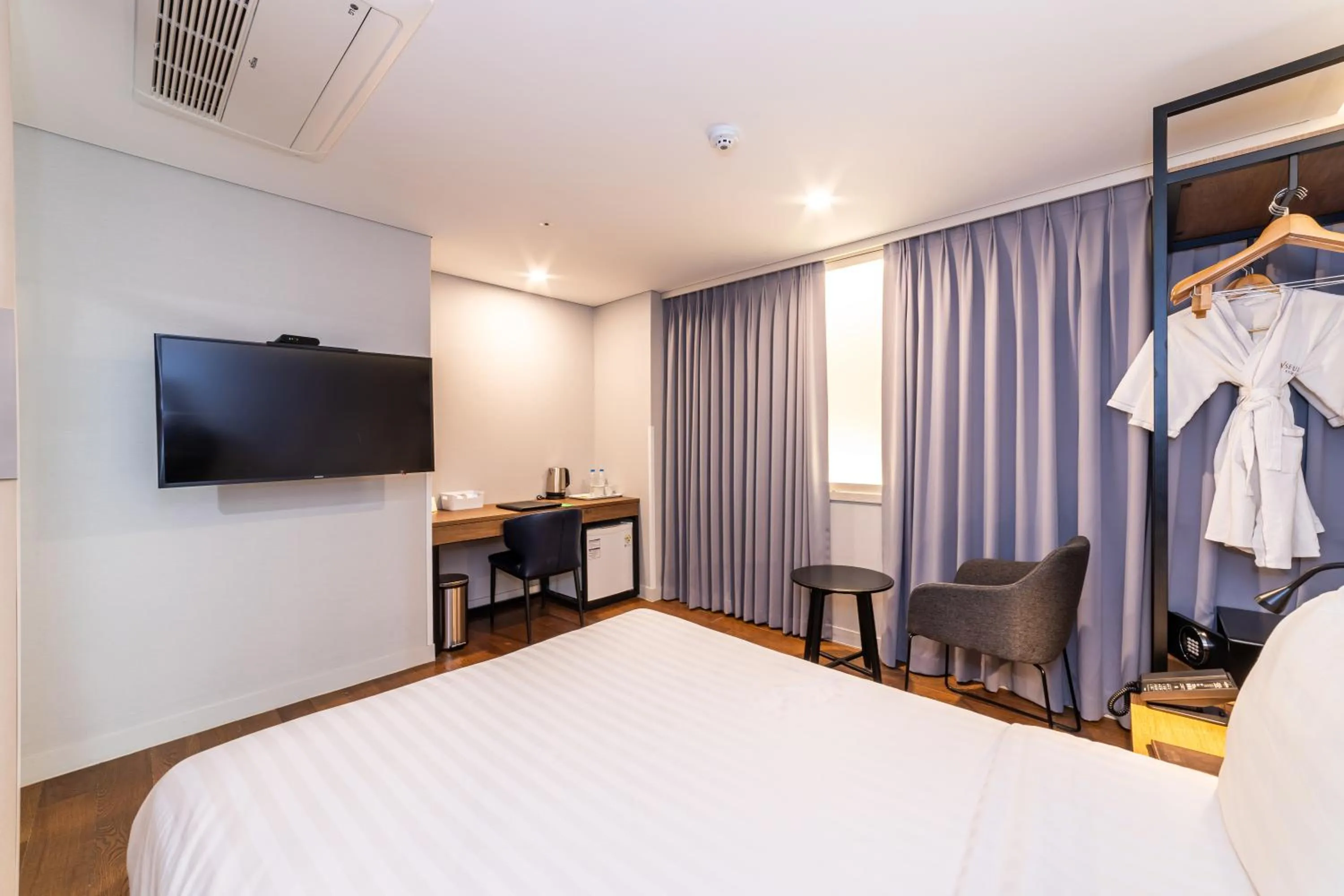 Bed in New Seoul Hotel Myeongdong