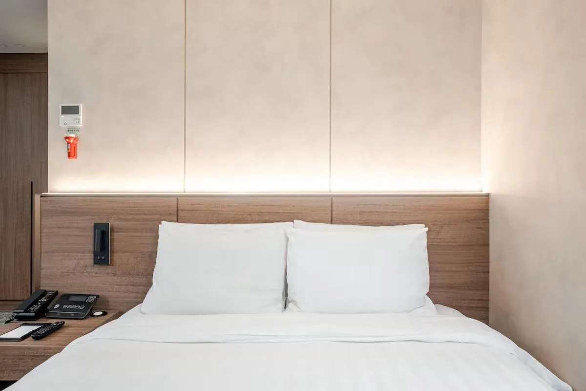 Bed in New Seoul Hotel Myeongdong