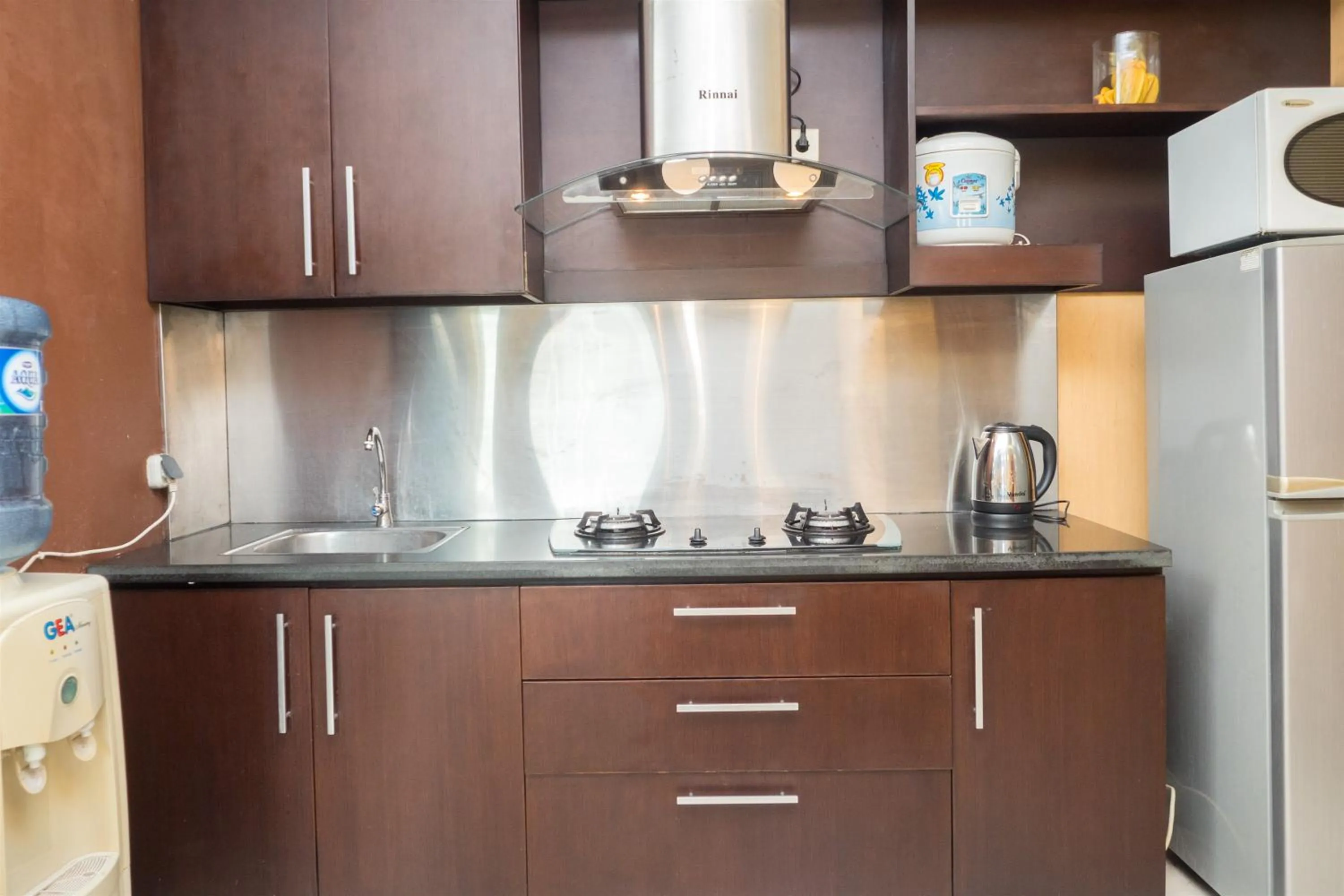 Kitchen or kitchenette in Antique 3BR at Grand Setiabudi Apartment By Travelio