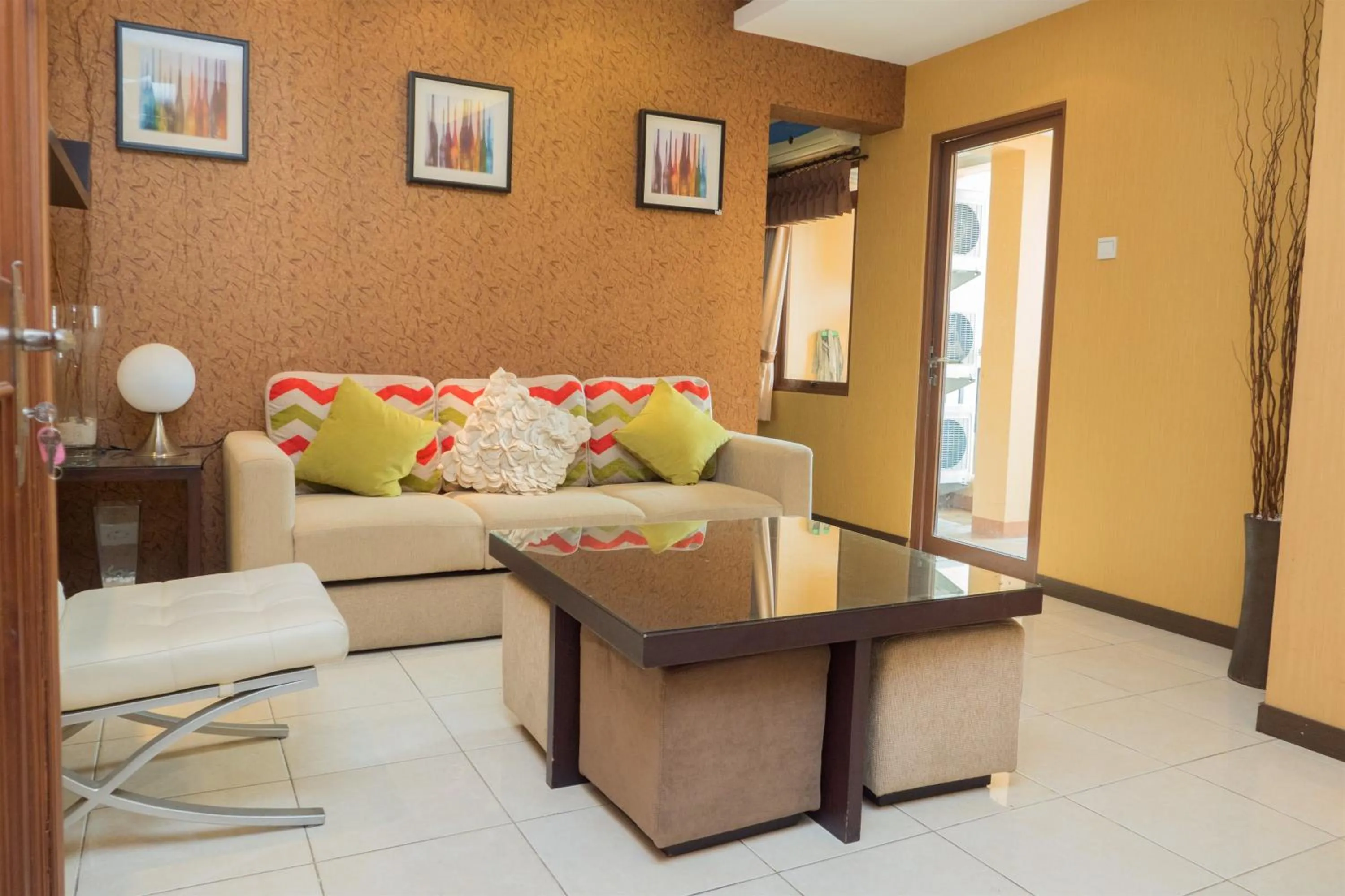 Living room in Antique 3BR at Grand Setiabudi Apartment By Travelio