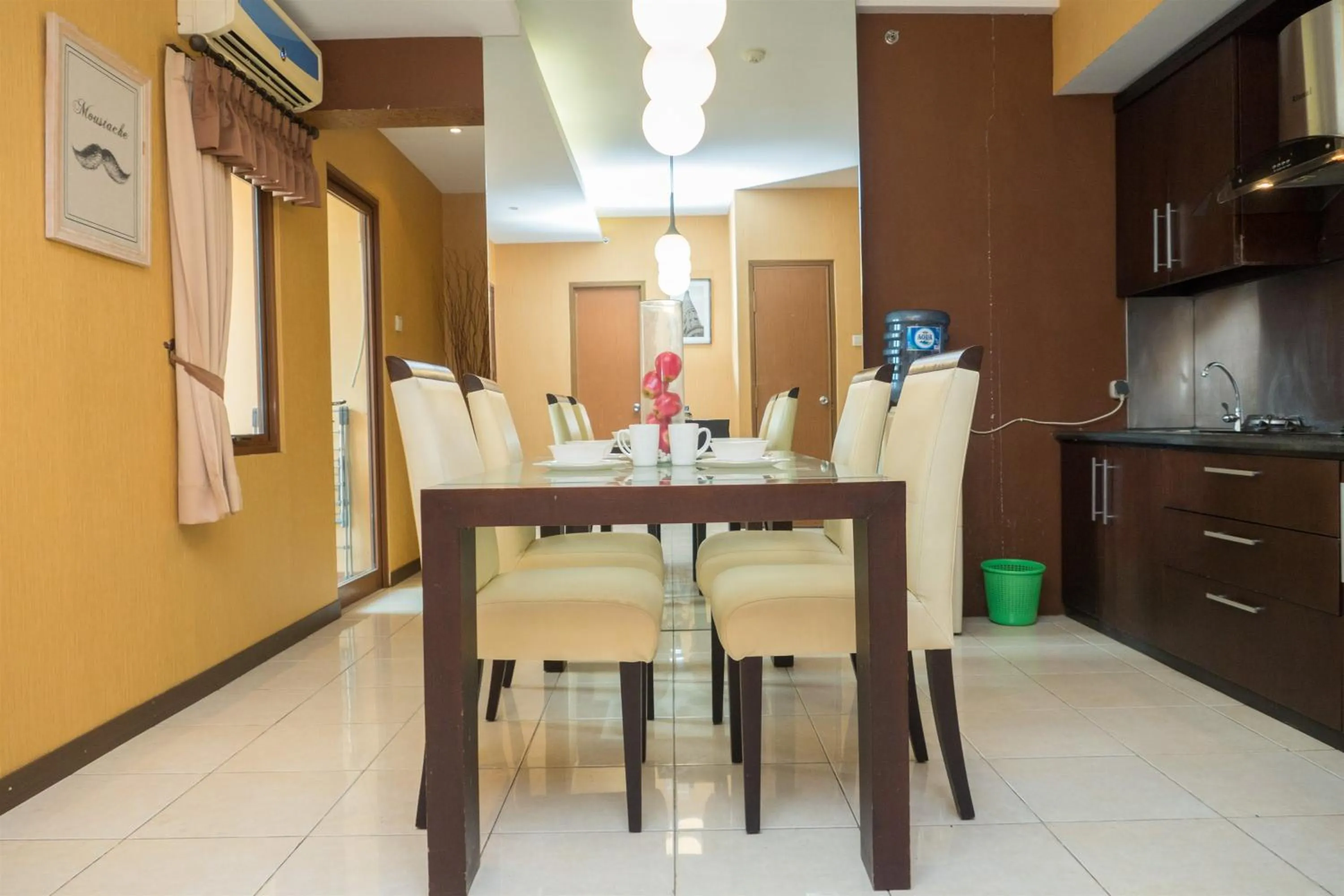 Dining area in Antique 3BR at Grand Setiabudi Apartment By Travelio