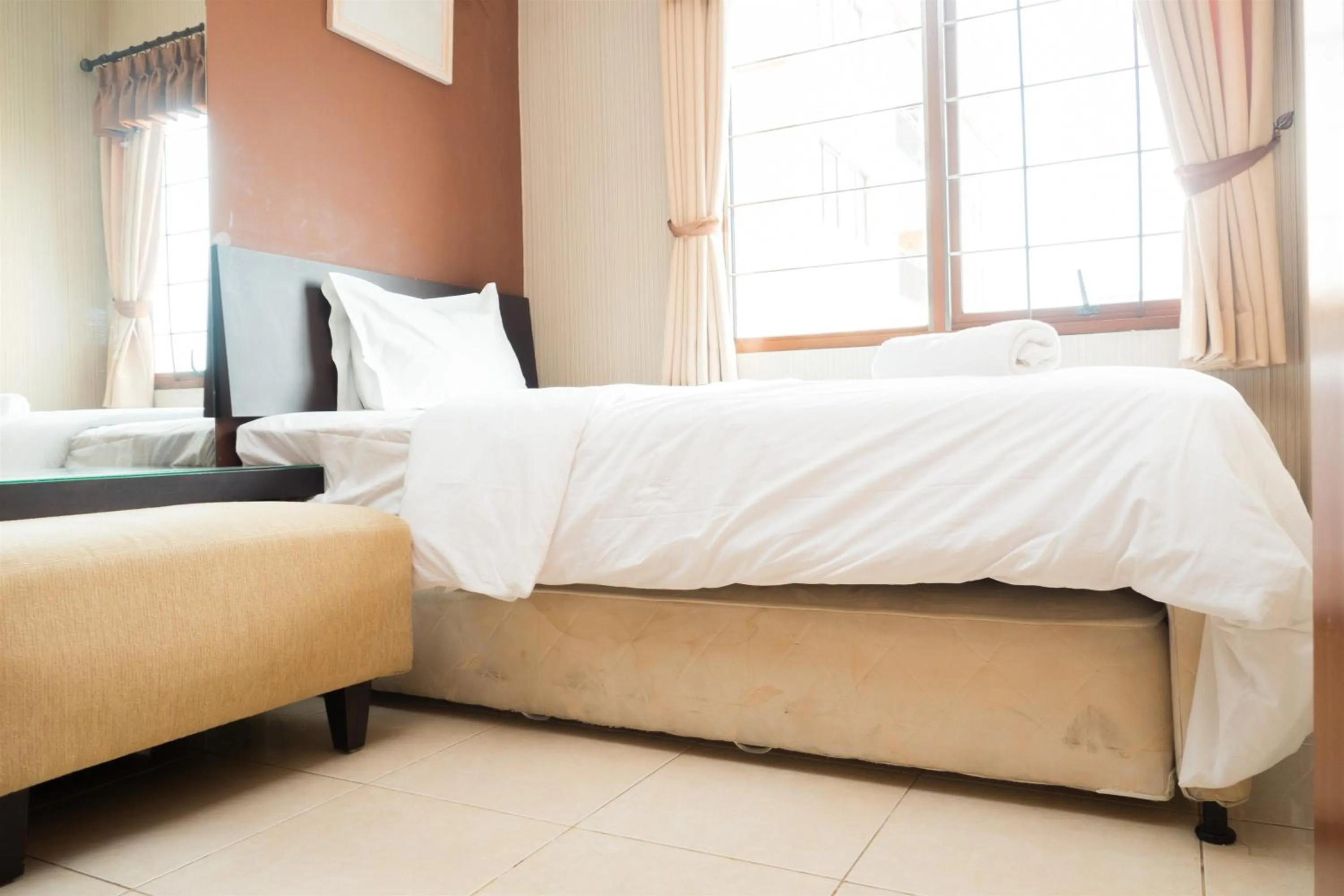 Bed in Antique 3BR at Grand Setiabudi Apartment By Travelio