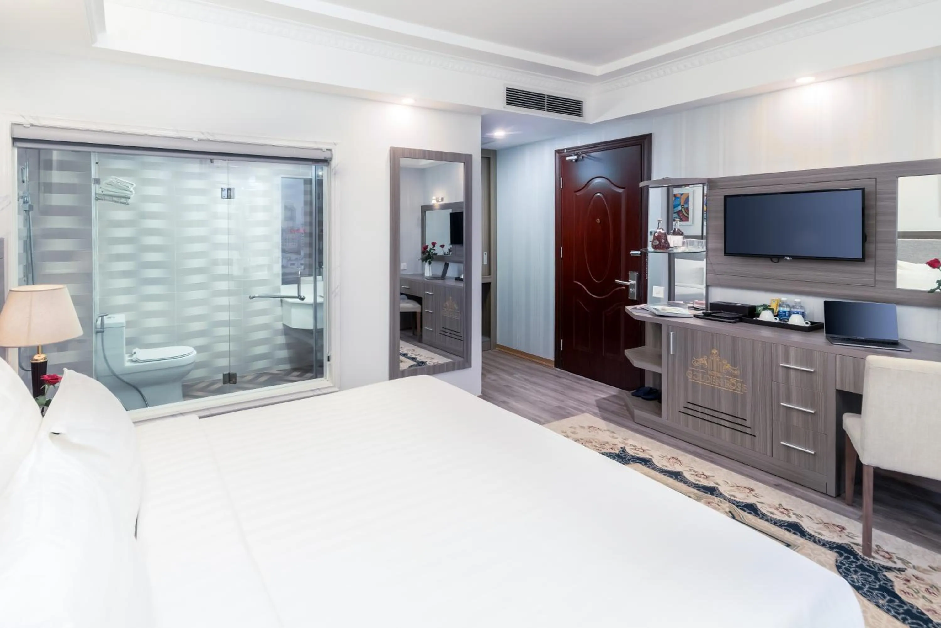 Communal lounge/ TV room, Bed in Golden Rose Hotel