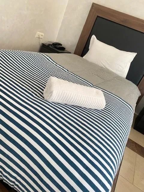 Bed in AMWAJ HOTEL