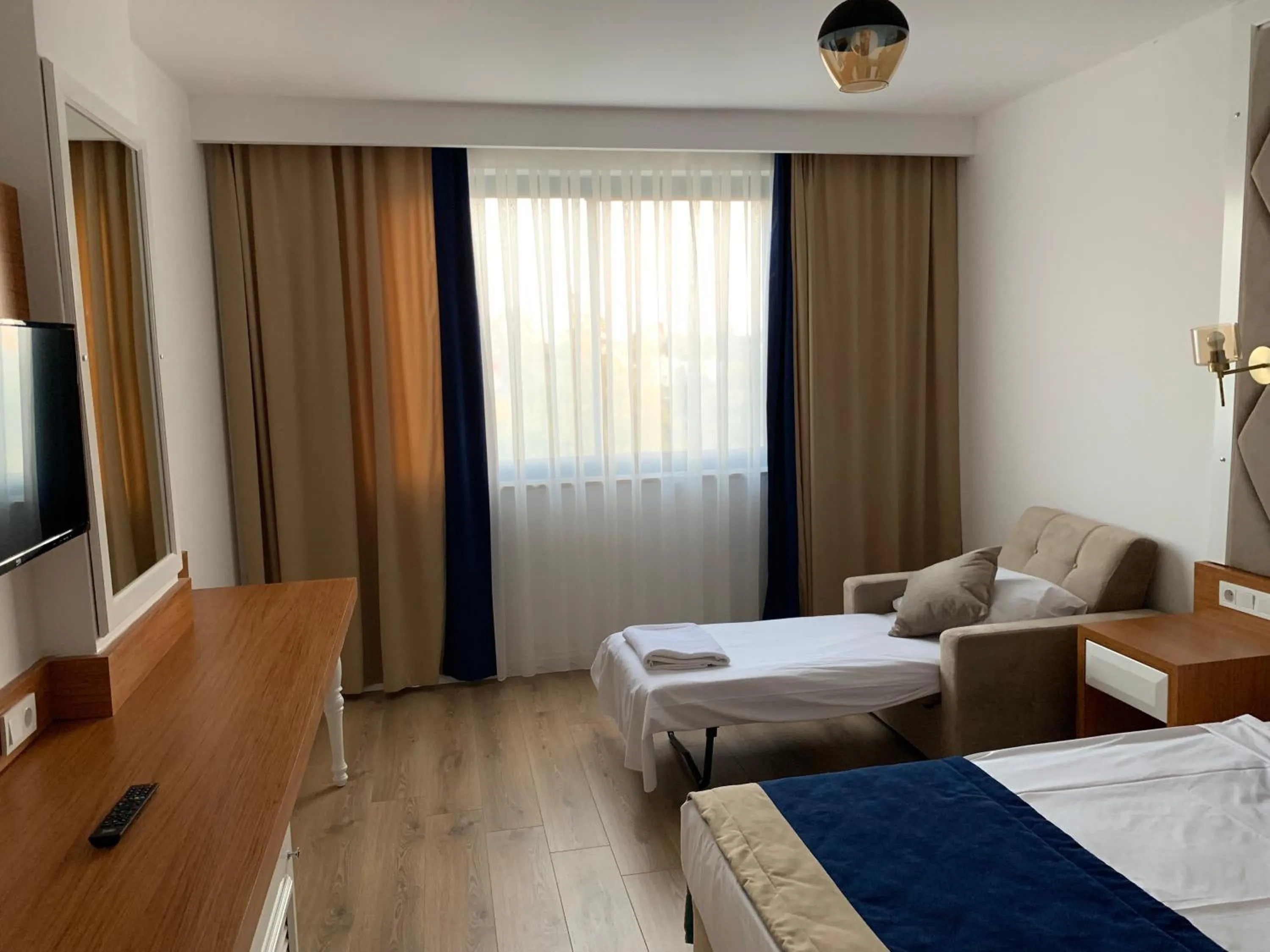 Bed in The Sansa Hotel & Spa