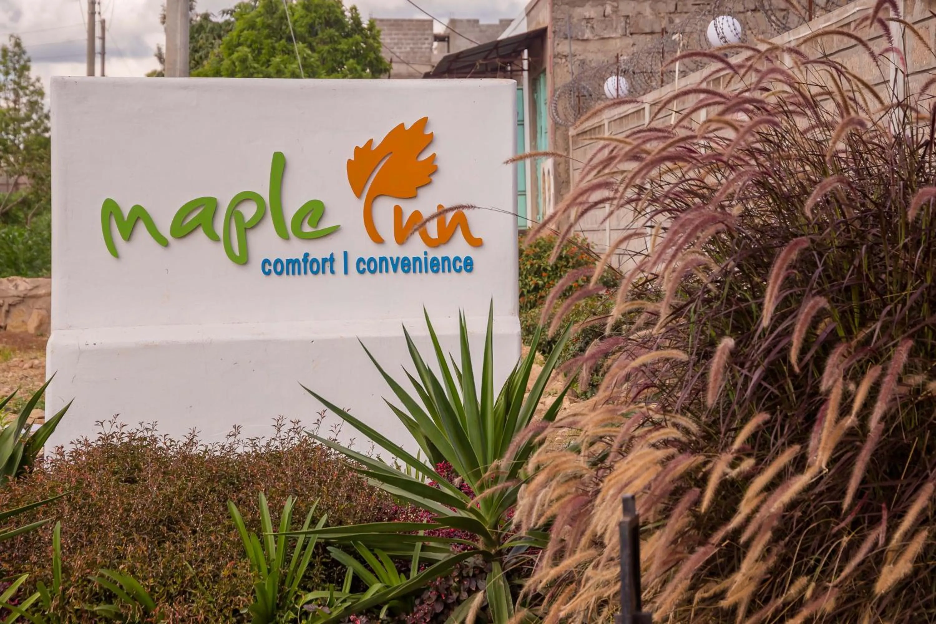 Property logo or sign in Maple Inn Hotel