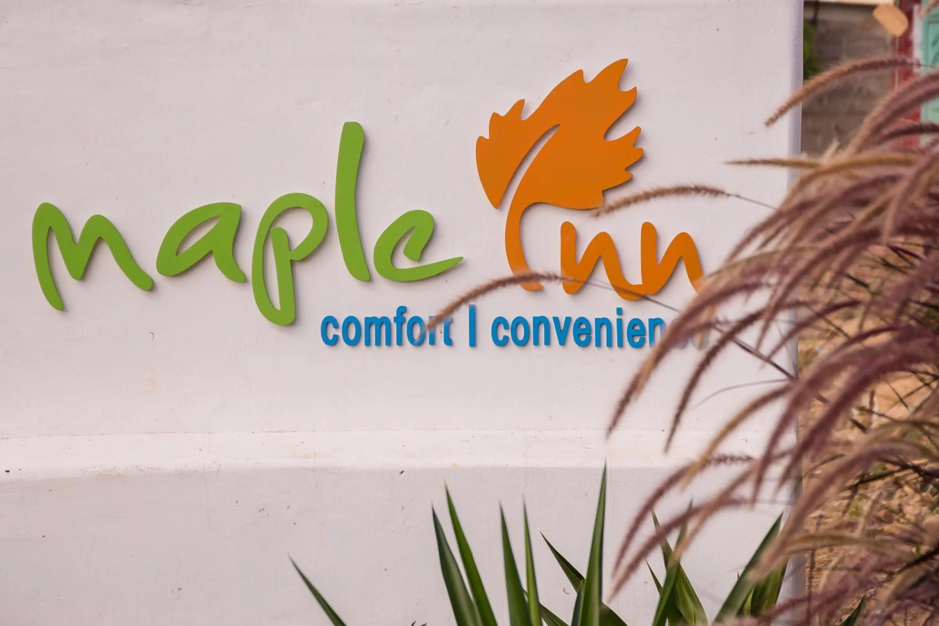 Property logo or sign in Maple Inn Hotel