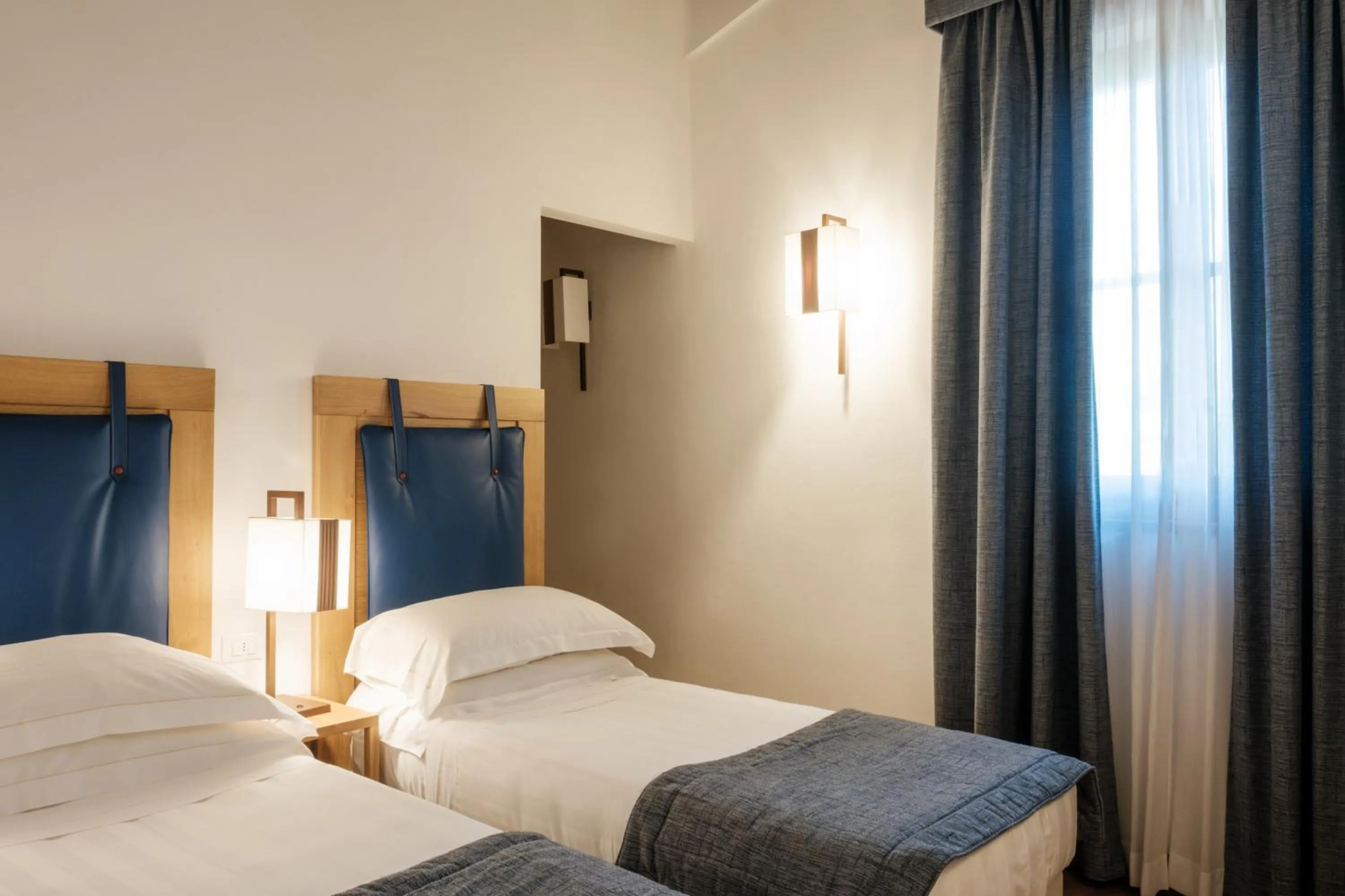 Bed in Villa Tolomei Hotel & Resort