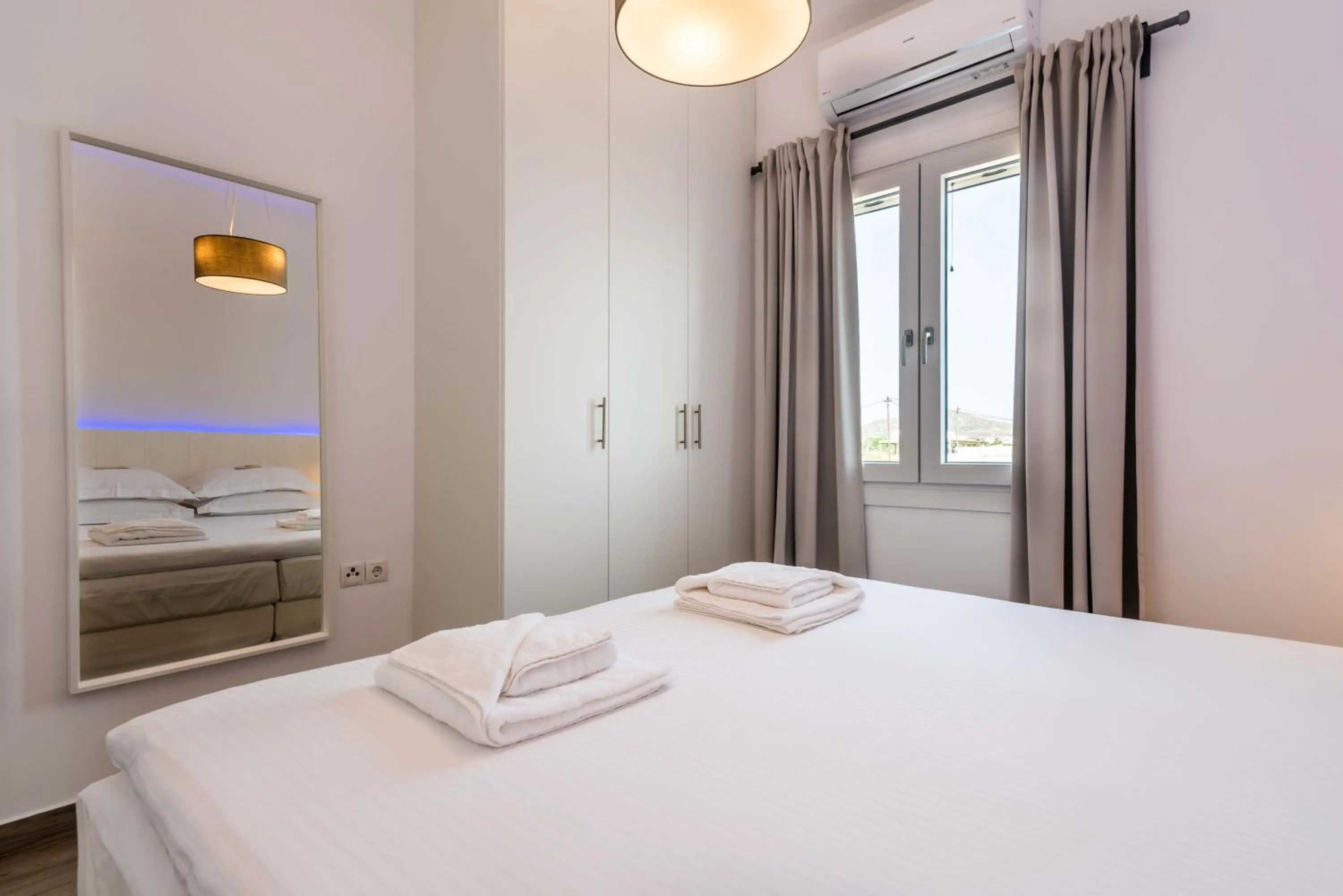 Bed in White Rock Milos Suites