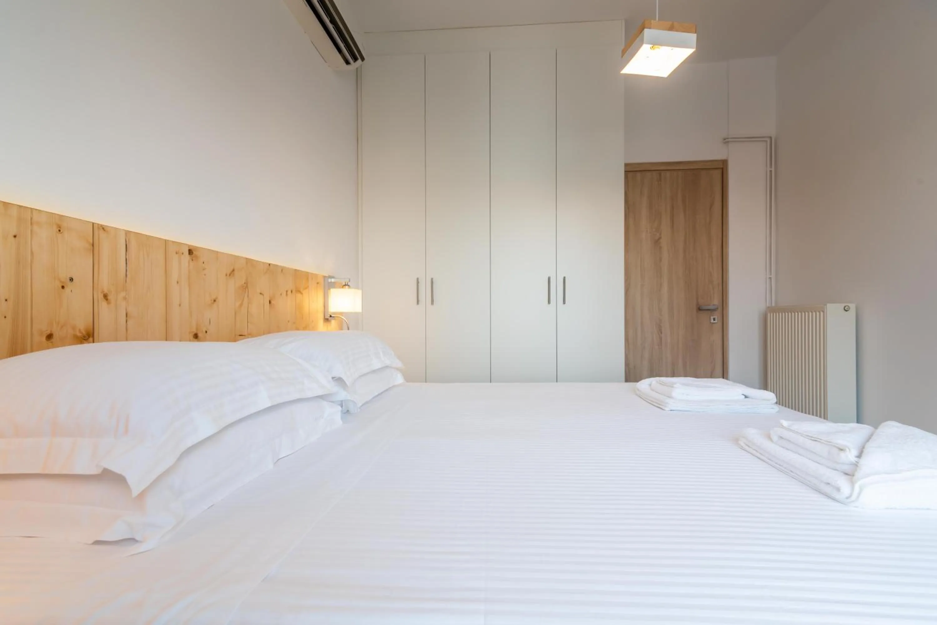 Bed in White Rock Milos Suites