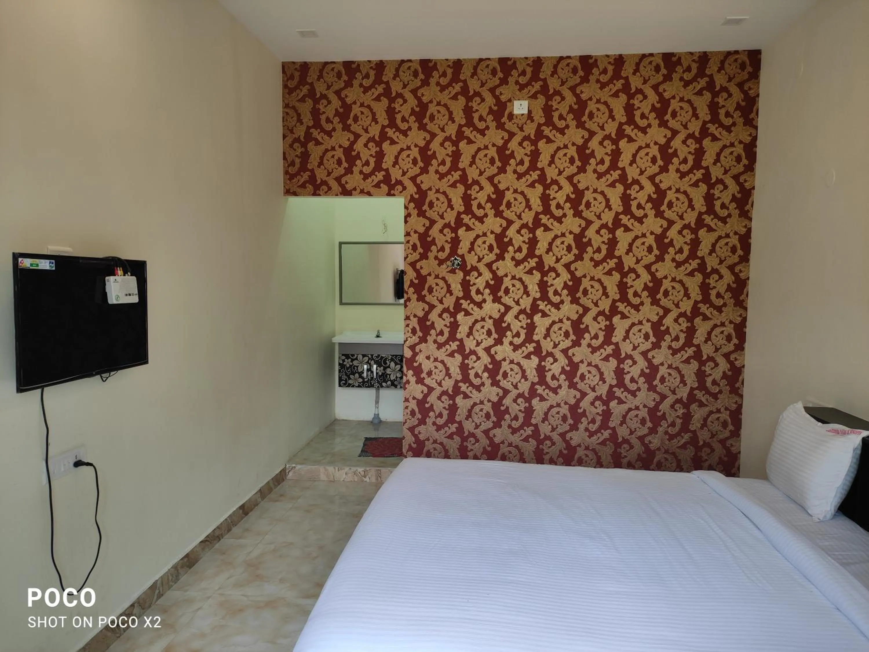 Bed in Sushmika Resorts Inn