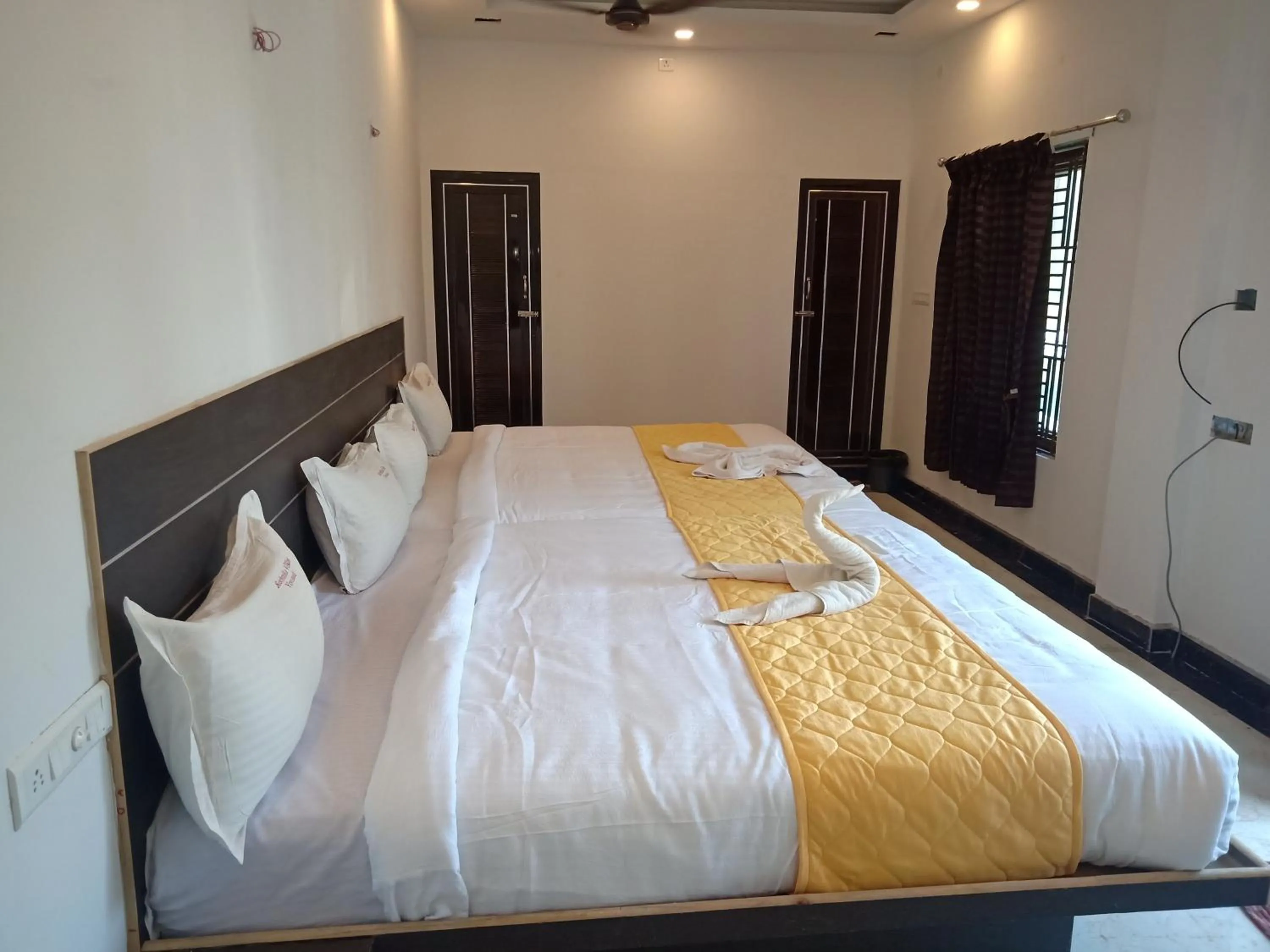 Bed in Sushmika Resorts Inn