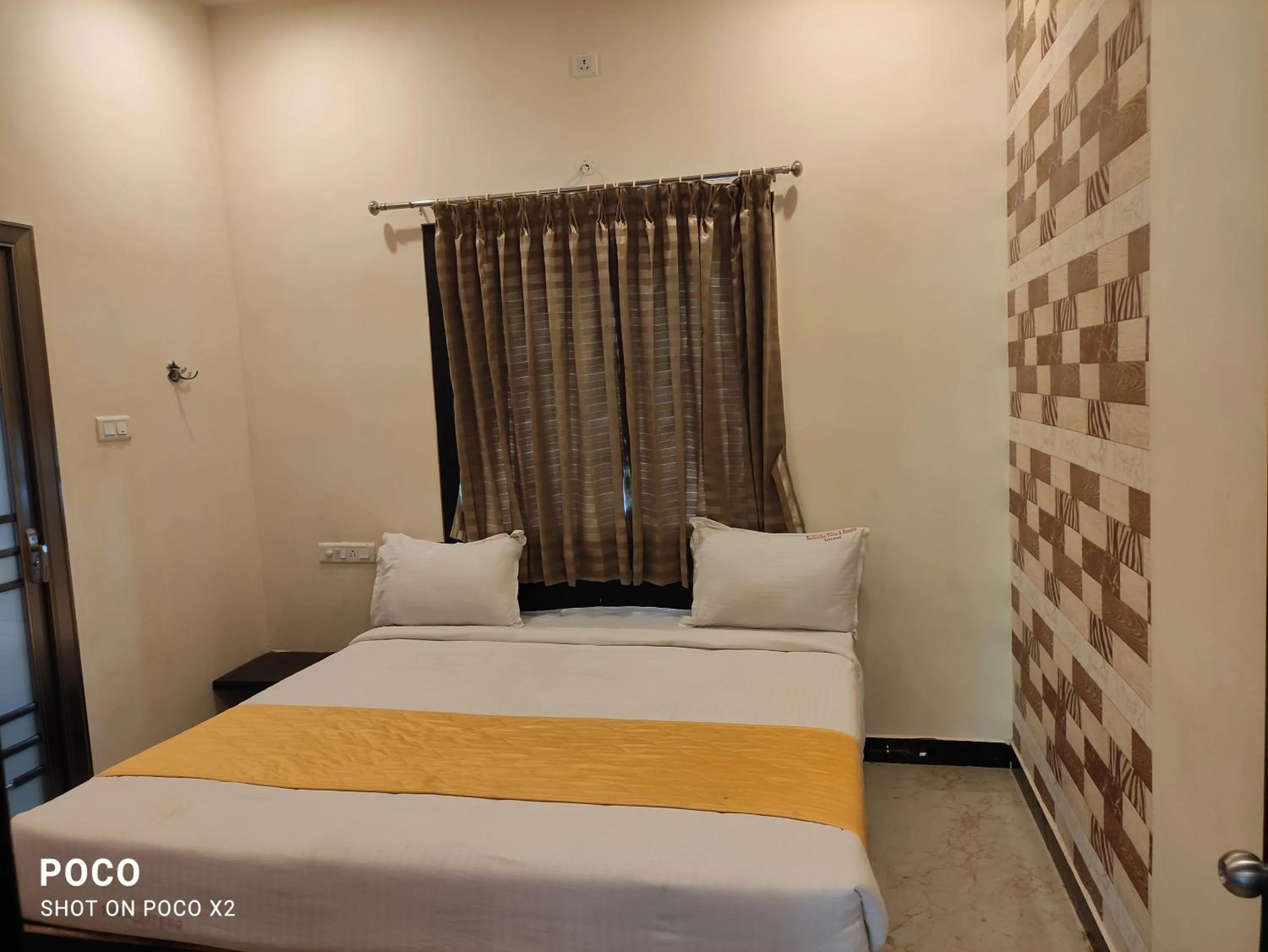Bed in Sushmika Resorts Inn