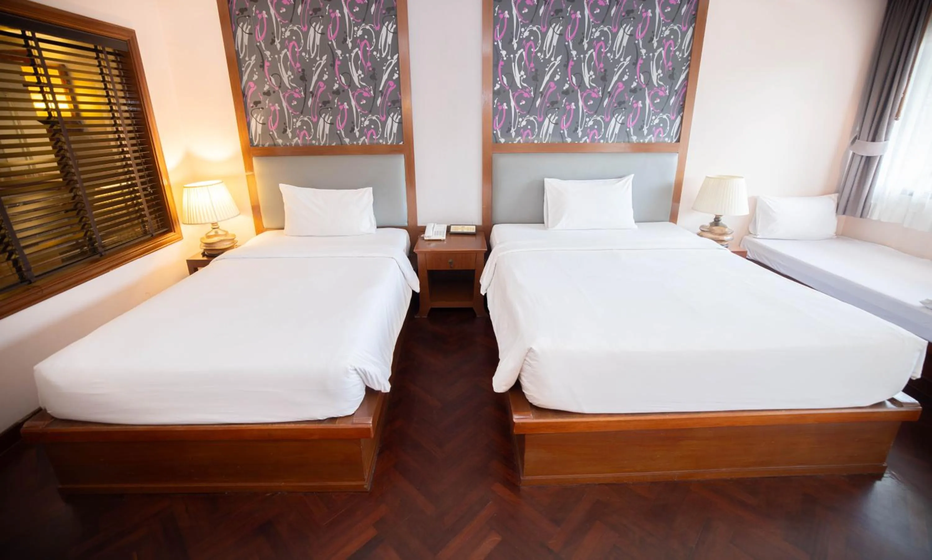 Bed in Baumanburi Hotel Patong