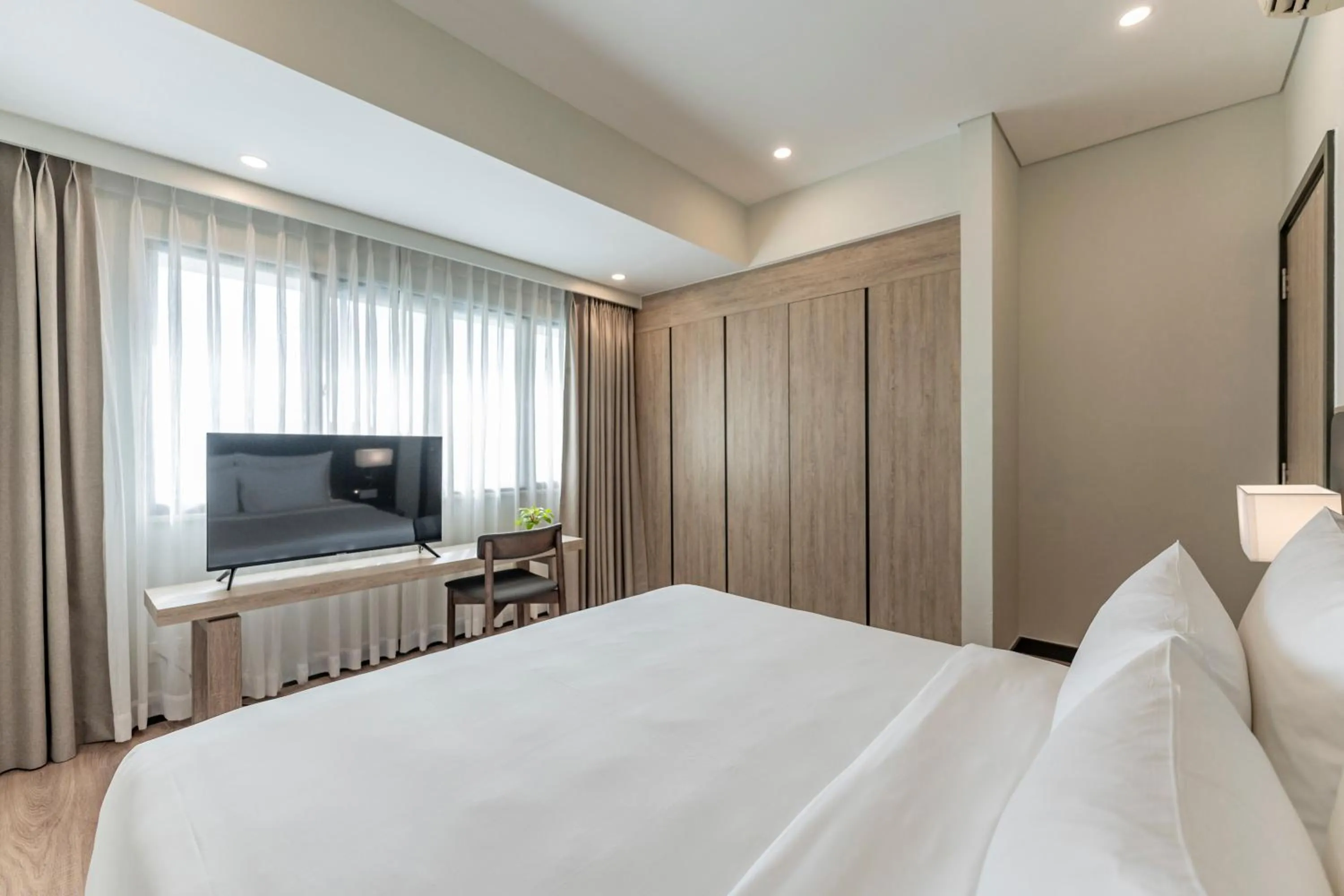 Communal lounge/ TV room, Bed in Garden View Court Suites Ho Chi Minh City