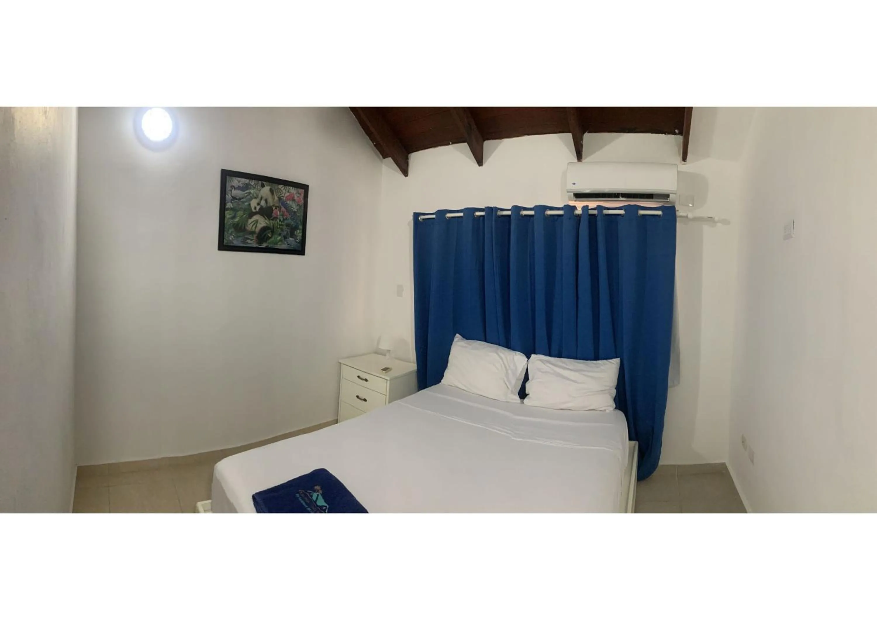 Bed in Karimar Beach Condo Hotel