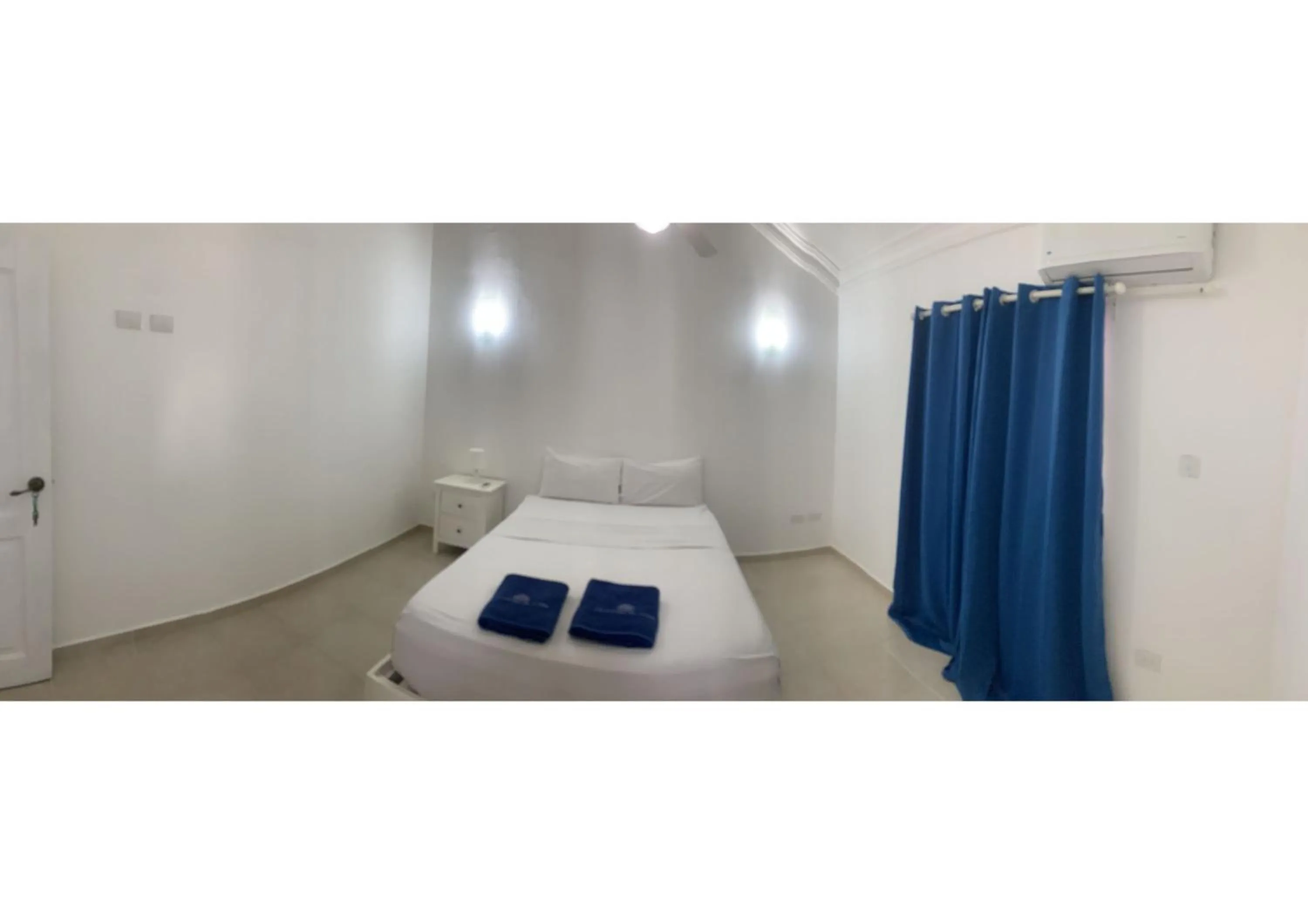 Bed in Karimar Beach Condo Hotel