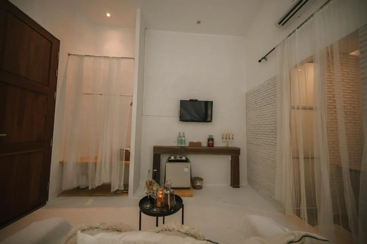 Bed in White Wall Riverfront Hotel