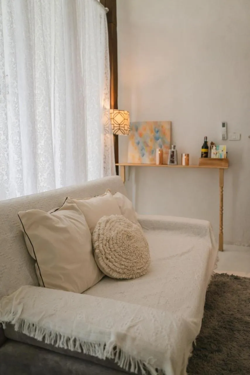 Bed in White Wall Riverfront Hotel