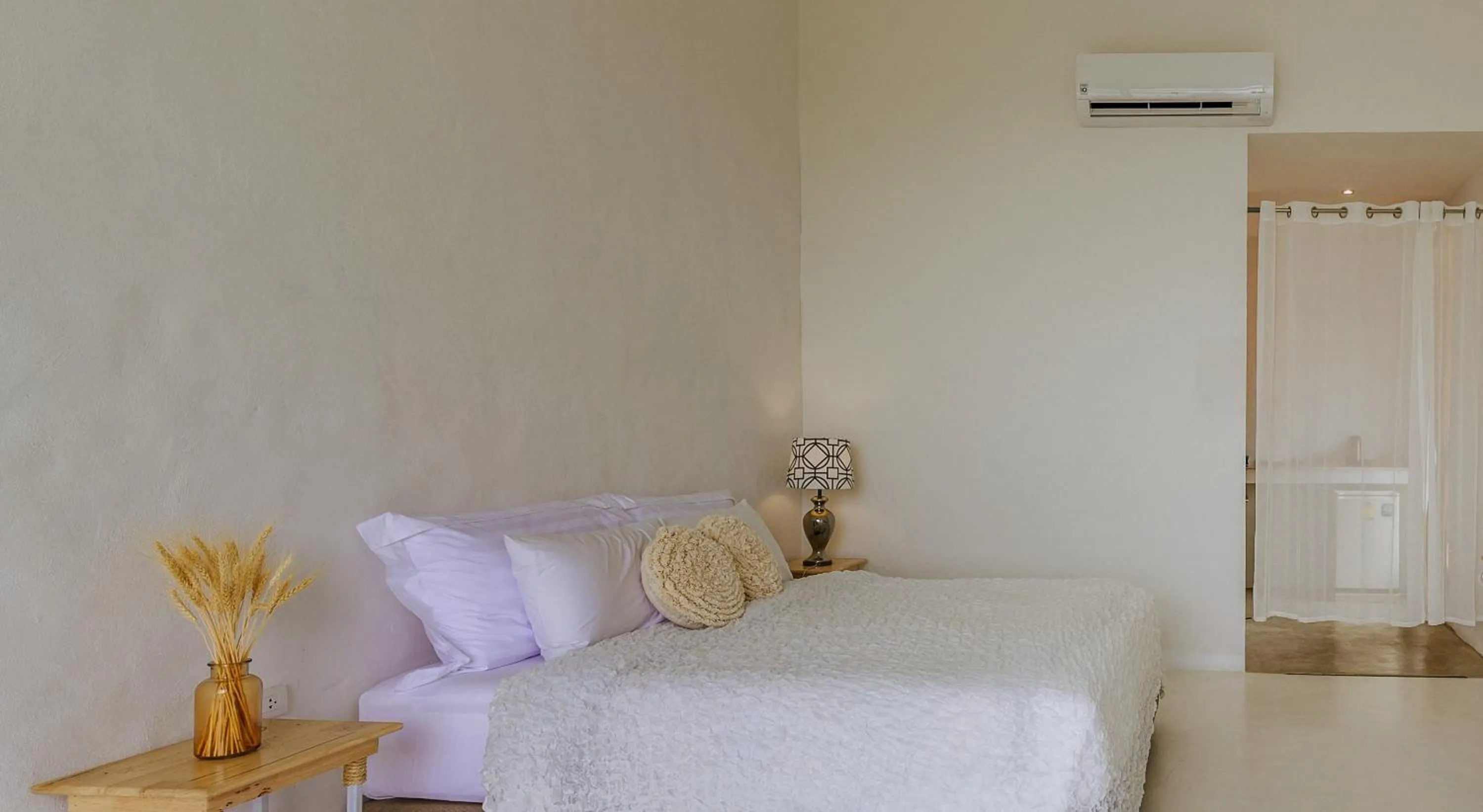 Bed in White Wall Riverfront Hotel