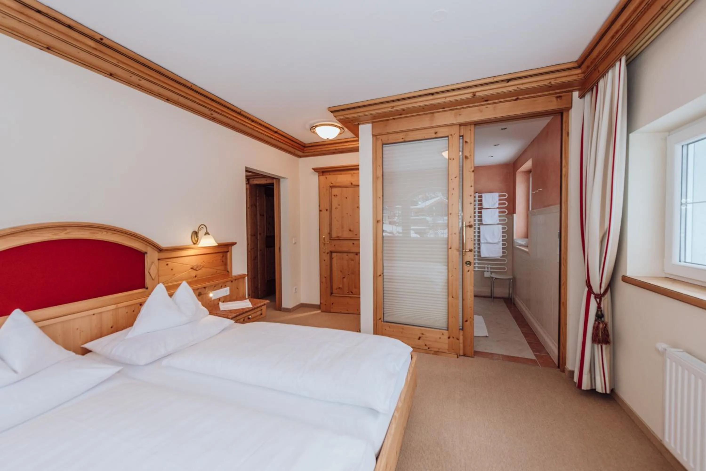 Bathroom, Bed in Hotel Ennstalerhof