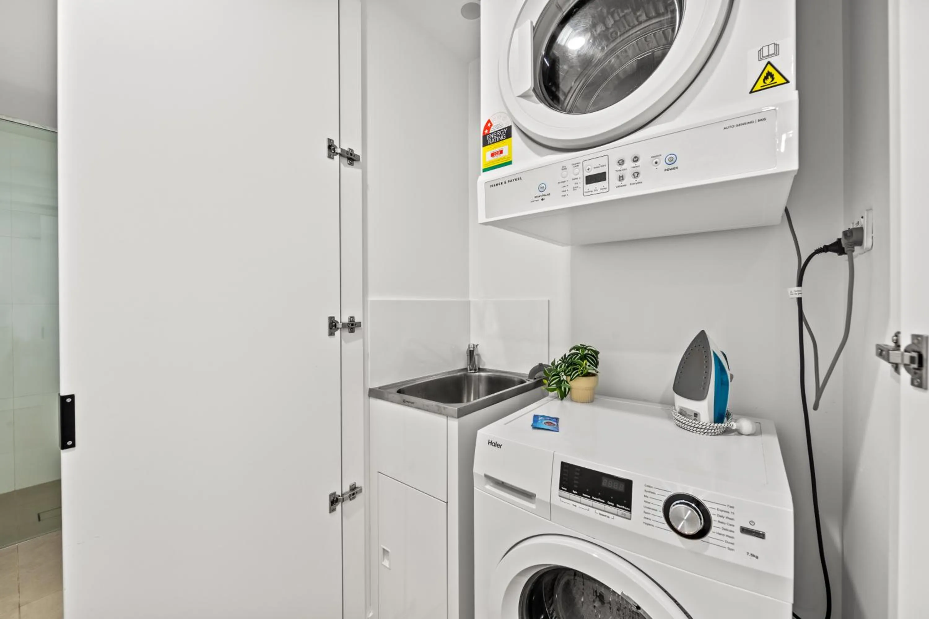 washing machine in Brisbane One Apartments by CLLIX