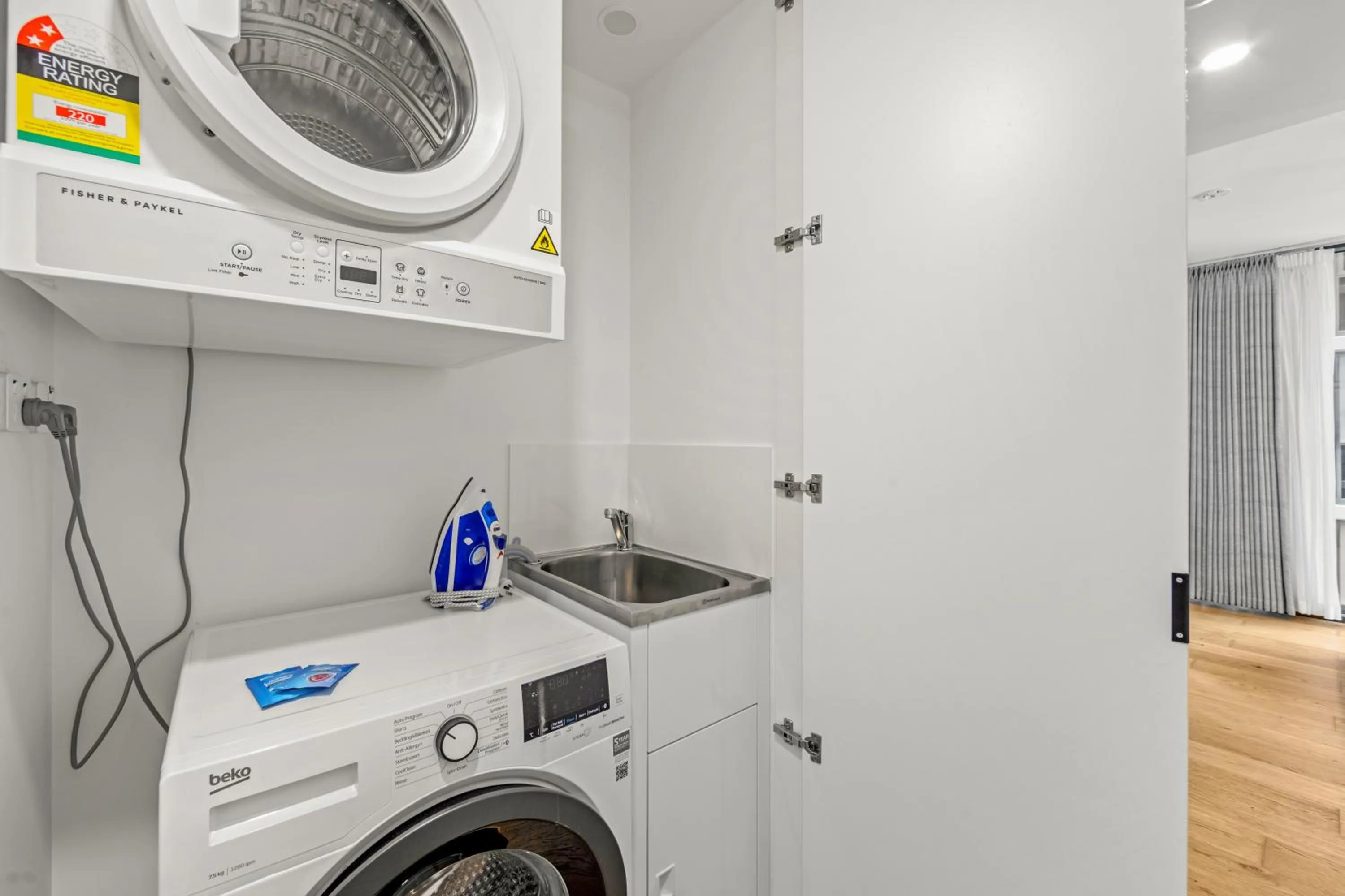 washing machine in Brisbane One Apartments by CLLIX