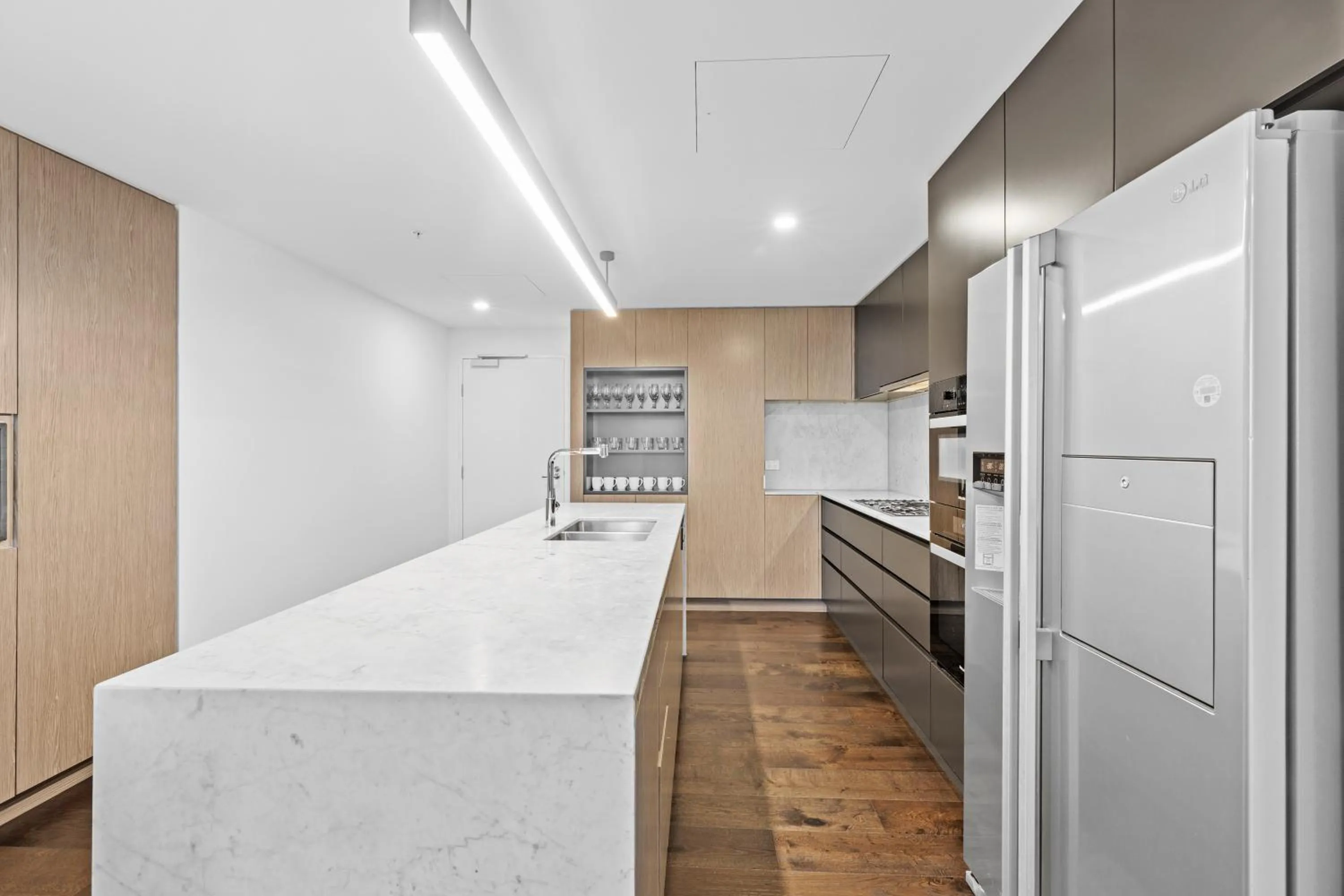 kitchen in Brisbane One Apartments by CLLIX