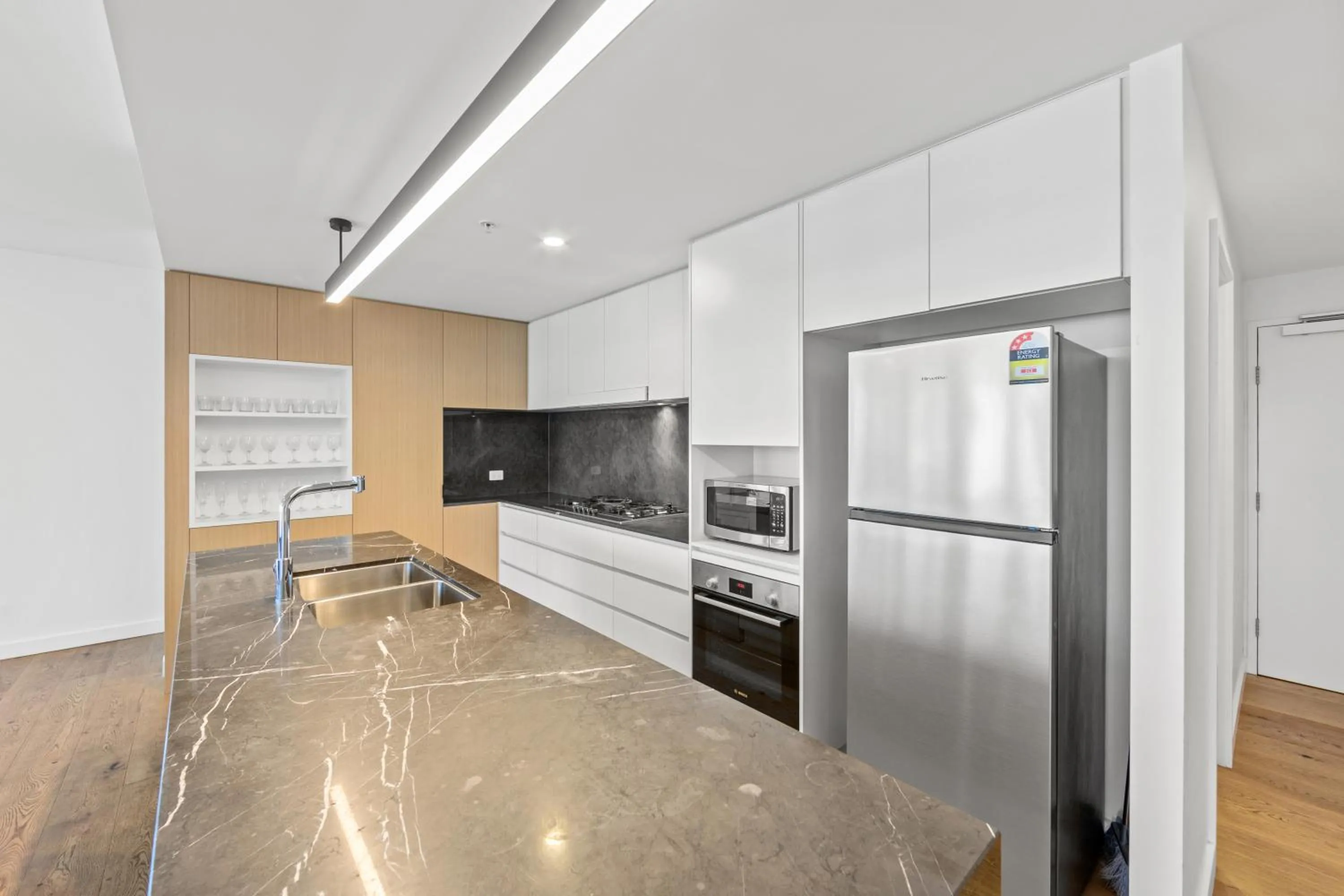 kitchen in Brisbane One Apartments by CLLIX