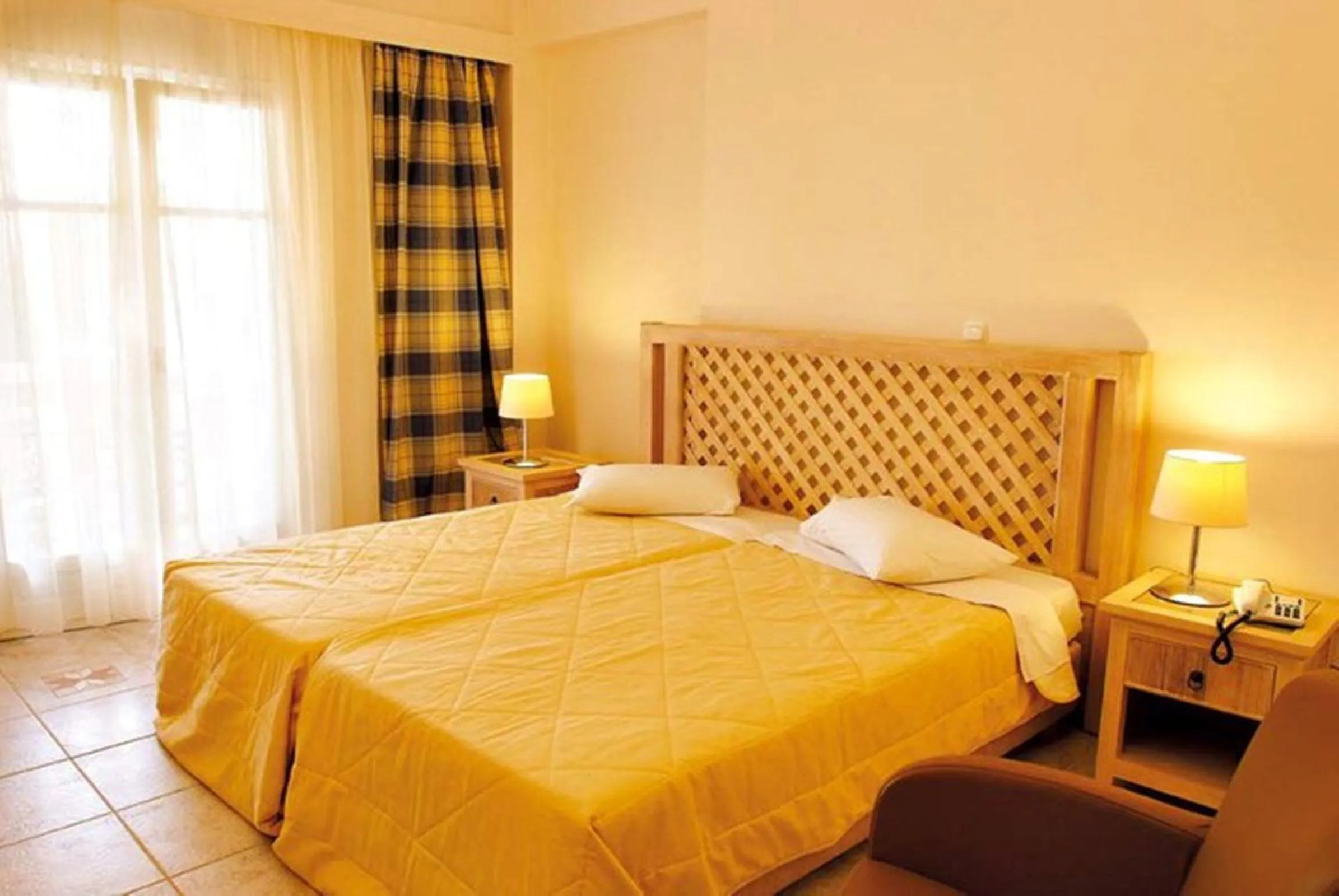 Bed in Alonissos Beach Bungalows And Suites Hotel