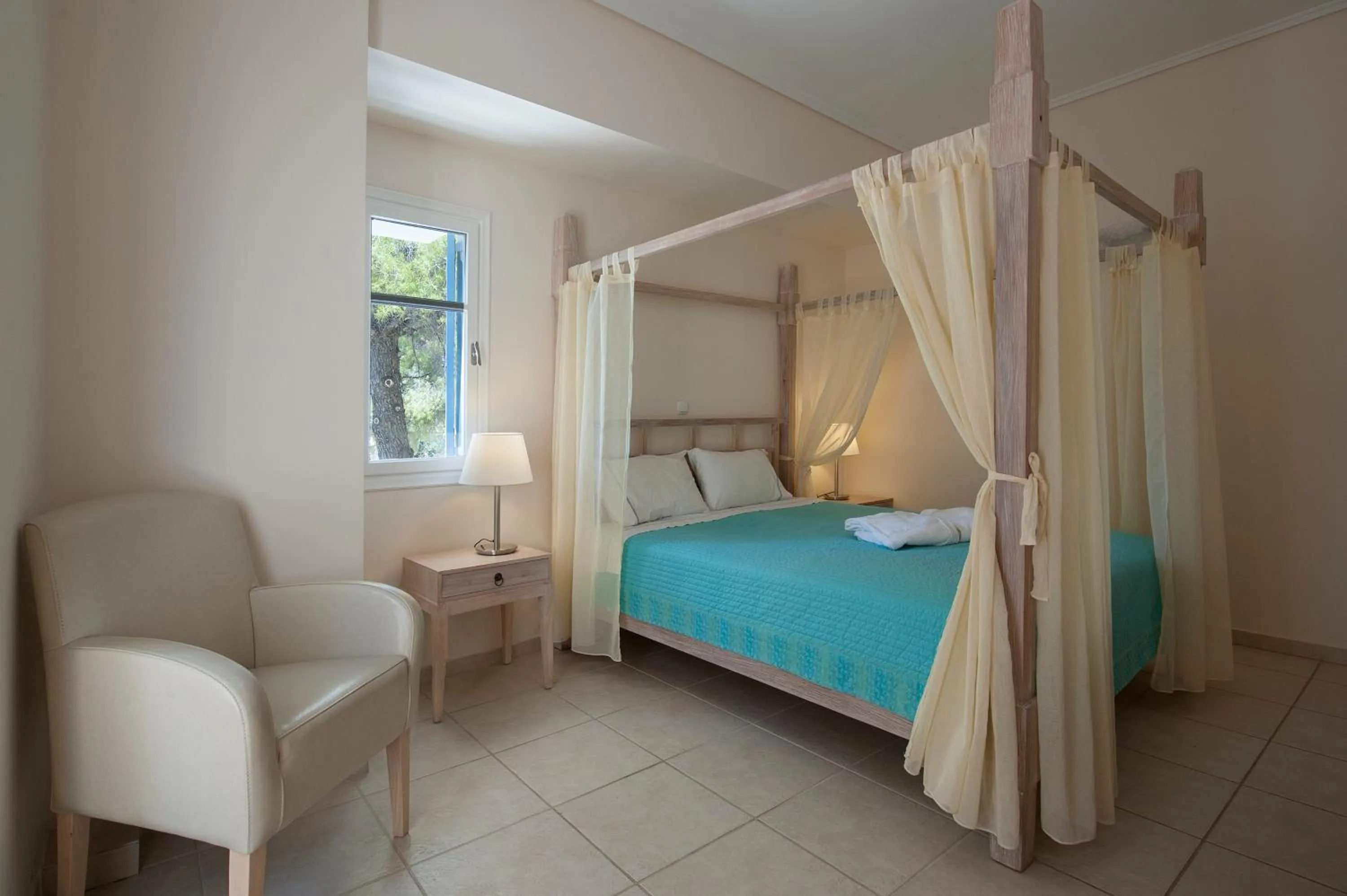 Bed in Alonissos Beach Bungalows And Suites Hotel